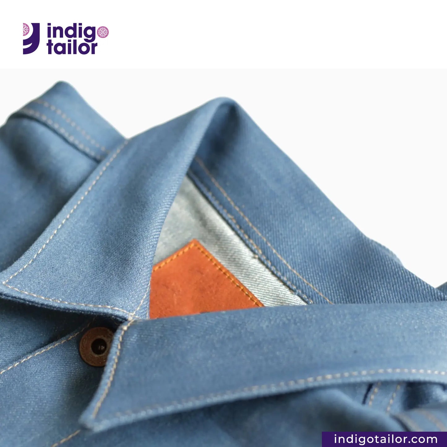 Close-up of a AOZORA SKY BLUE TYPE II PLUS JACKET with an orange patch, featuring the Indigotailor logo.