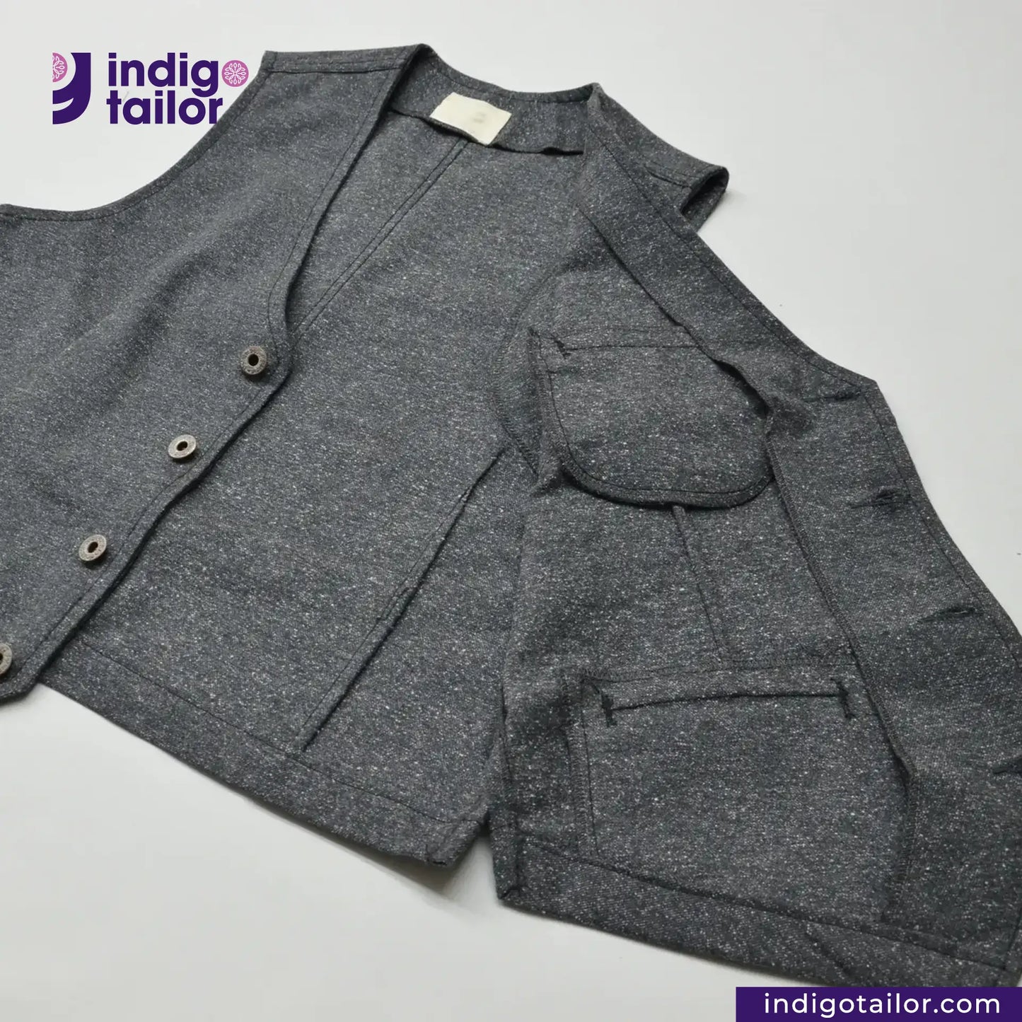 BLACK TWEED WORK VEST with a brand logo on a light gray background