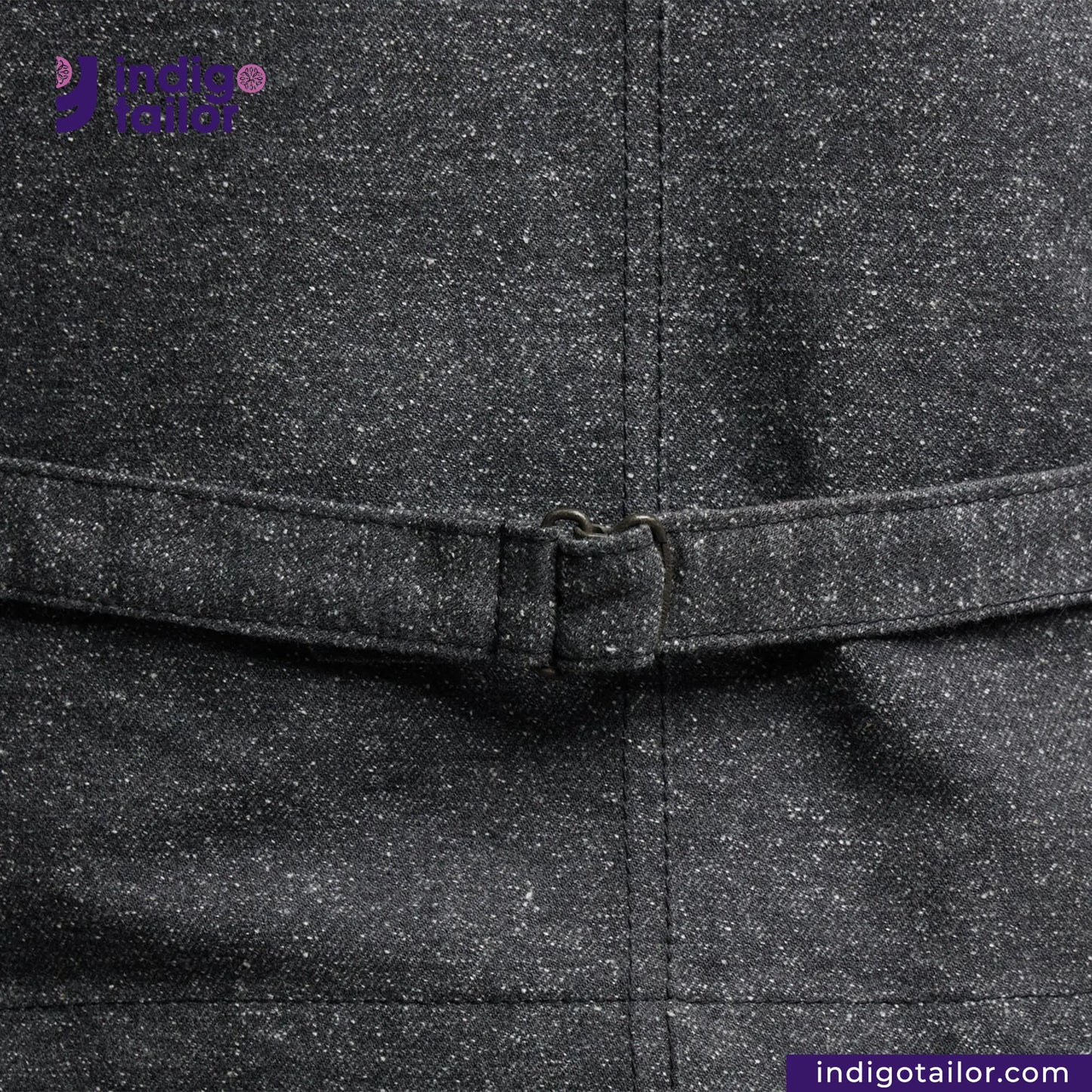 Close-up of a BLACK TWEED WORK VEST with a belt buckle, featuring the Indigo Tailor logo.