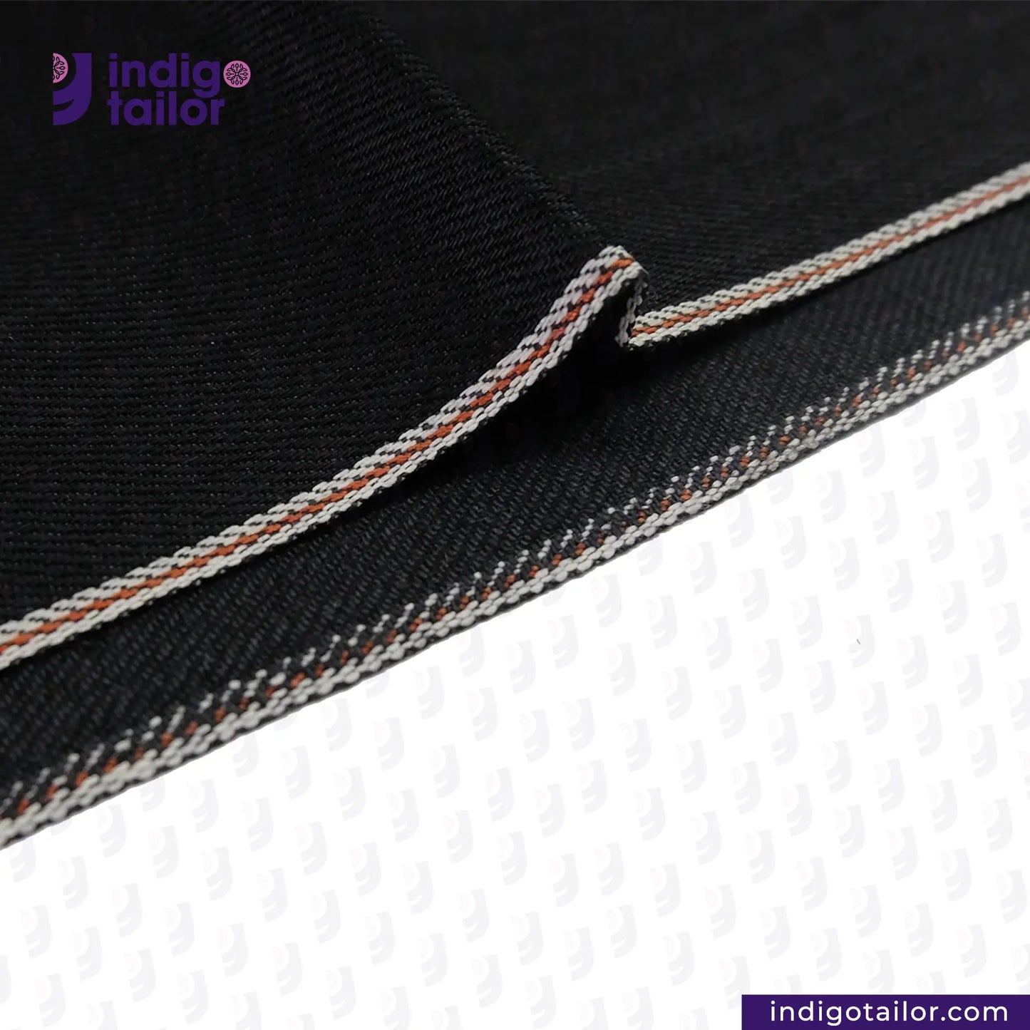 Close-up of BLACK x BLACK SEVLEDGE DENIM fabric with white and brown stitching, featuring the Indigotailor logo.