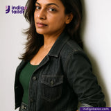 Woman wearing a CLASSIC BLACK SELVEDGE DENIM jacket against a white wall with 'Indigo Tailor' branding.