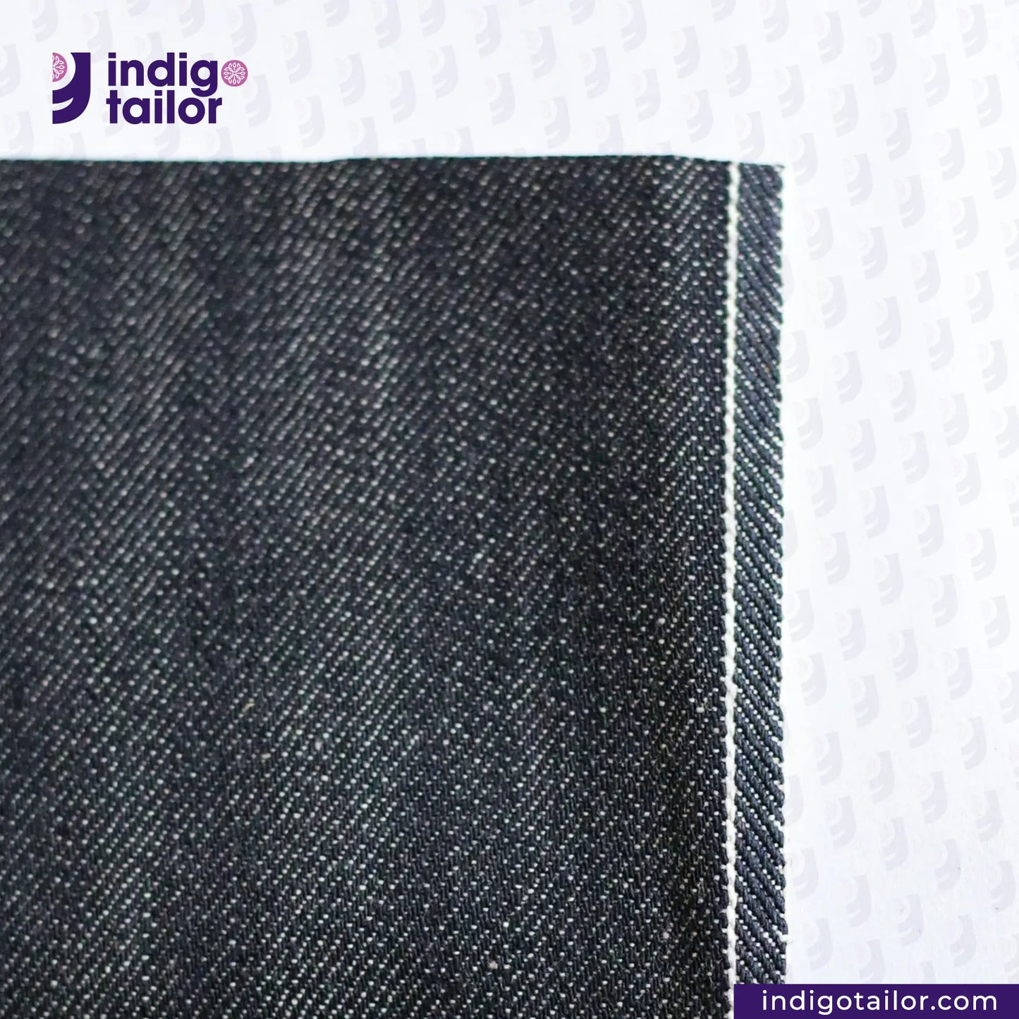 Close-up of CLASSIC BLACK SELVEDGE DENIM fabric with 'Indigo Tailor' logo and website URL at the bottom.