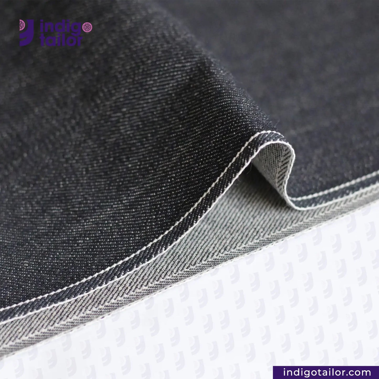 Close-up of CLASSIC BLACK SELVEDGE DENIM fabric with 'Indigotailor' branding.