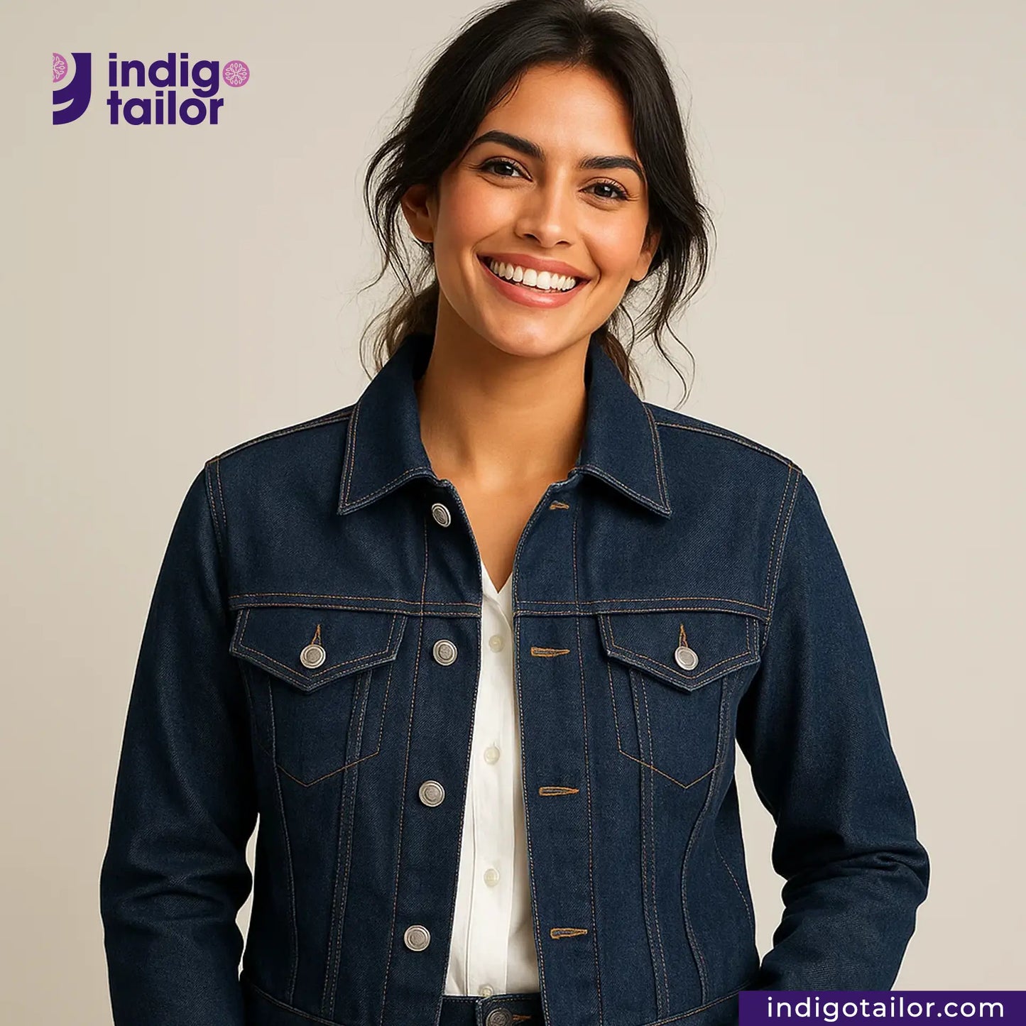 Woman wearing a COMFORT STRETCH WHITE SELVEDGE jacket with Indigotailor logo and website on a beige background