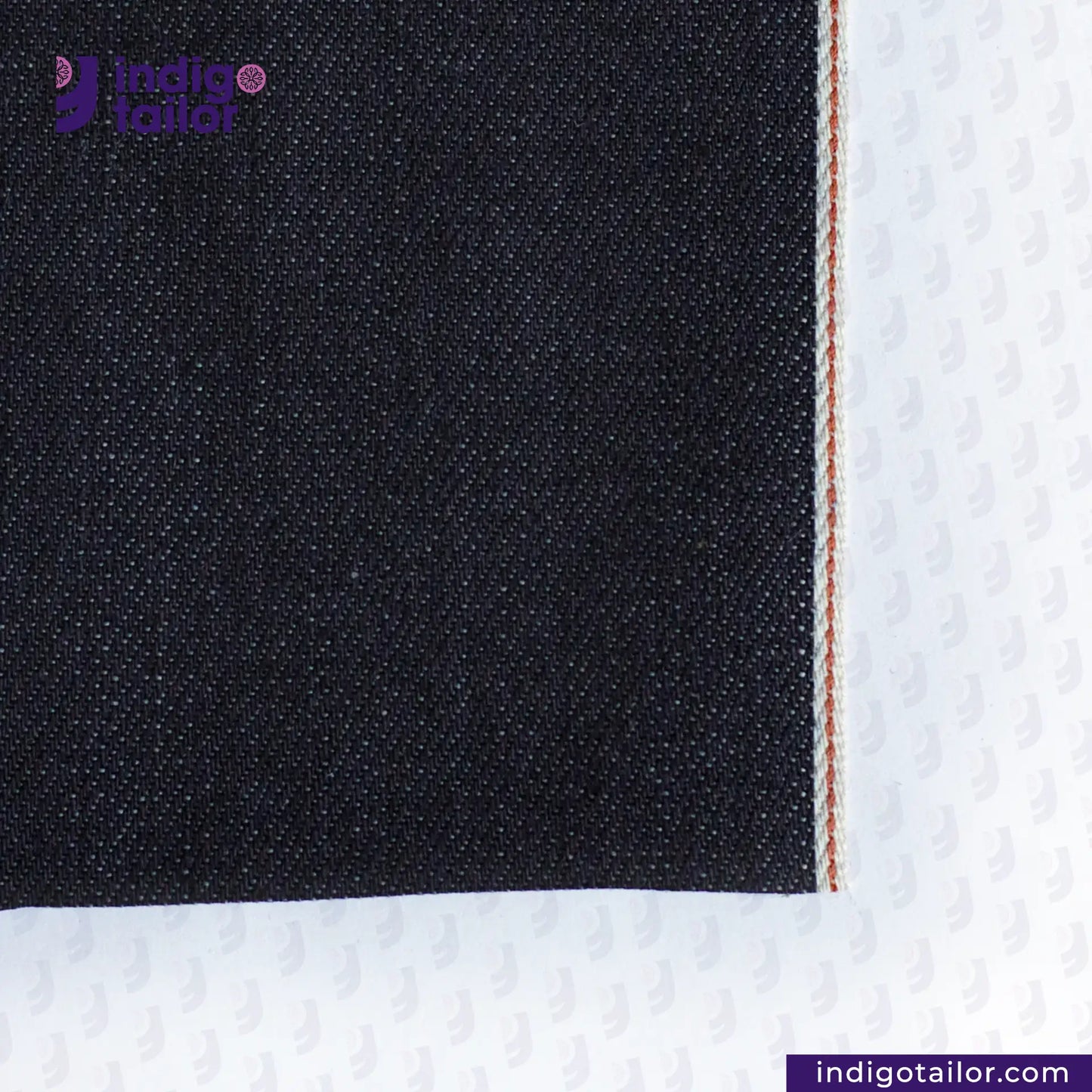 Close-up of DEEP INDIGO BURNT ORANGE COPPER SELVEDGE ID denim fabric corner with white border, featuring 'Indigo Tailor' logo.