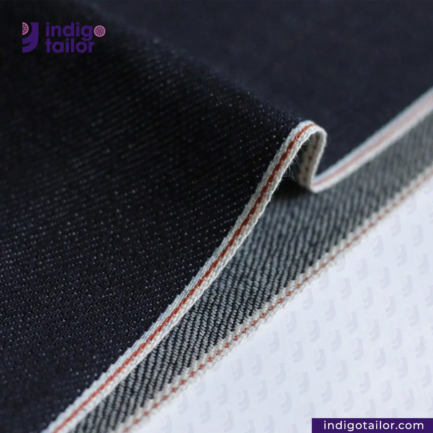 Close-up of DEEP INDIGO BURNT ORANGE COPPER SELVEDGE ID fabric with 'Indigotailor' branding.