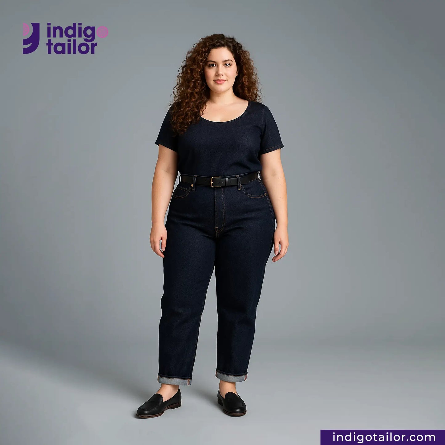 Woman wearing a DEEP INDIGO TWO COLORED EDGE SELVEDGE DENIM outfit with 'indigotailor' branding on a gray background