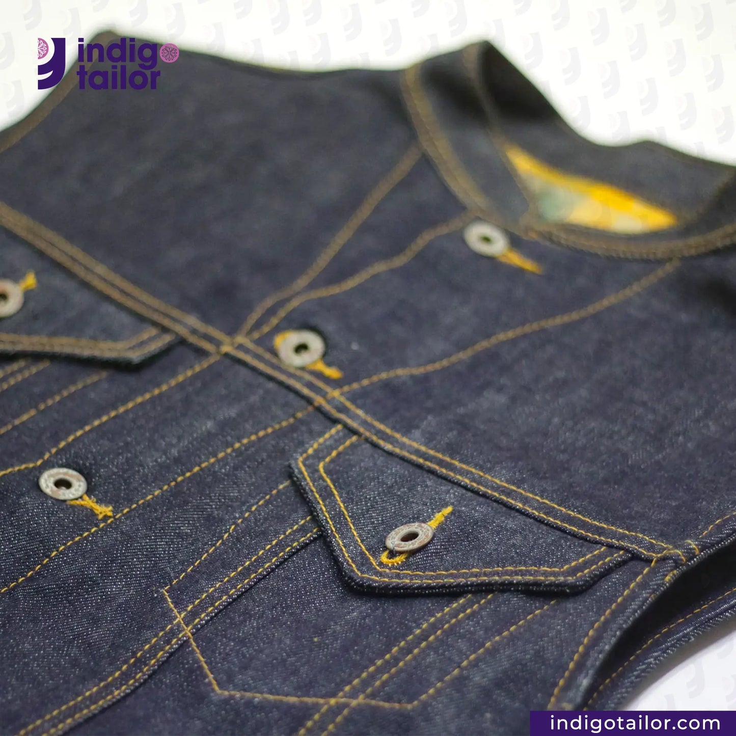 Close-up of a DENIM BIKER VEST with stitching details, featuring the 'indigotailor' brand.