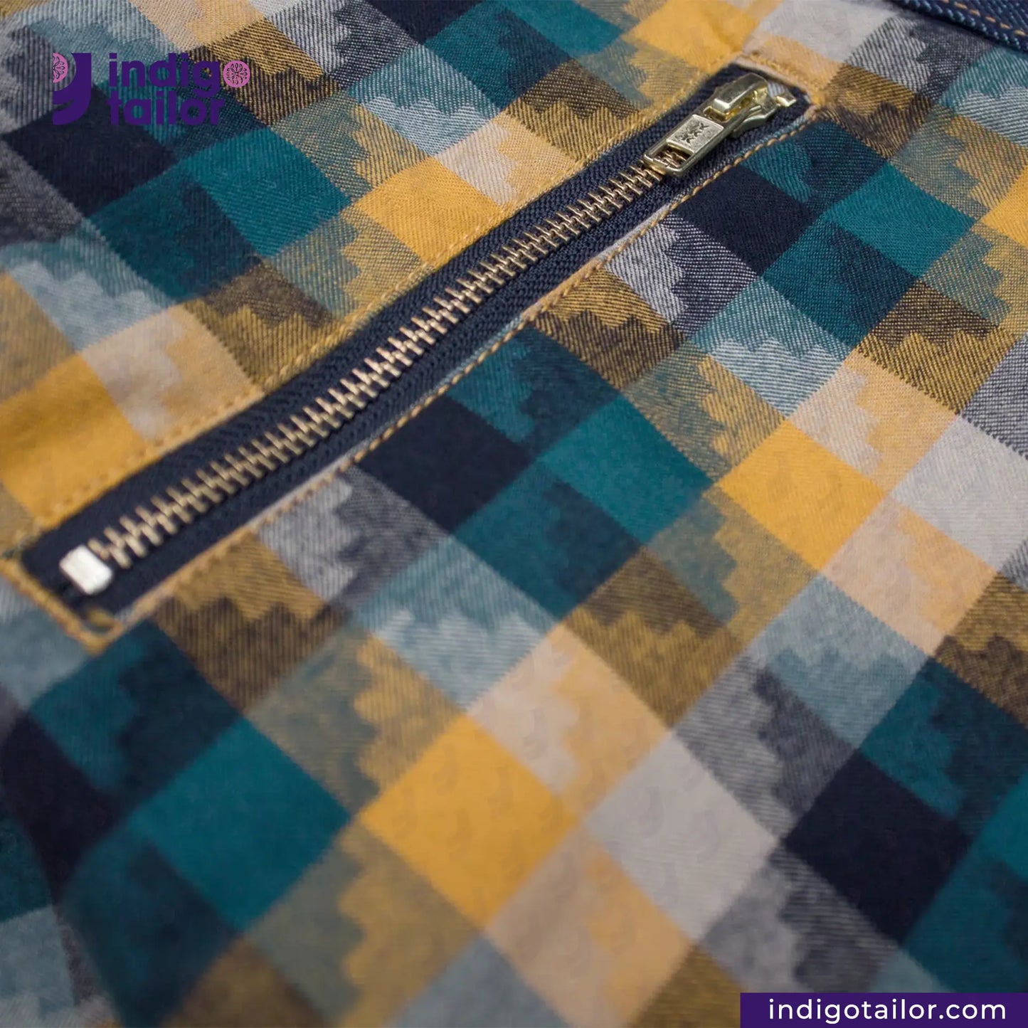 Close-up of a zipper on a DENIM BIKER VEST with 'Indigo Tailor' branding.