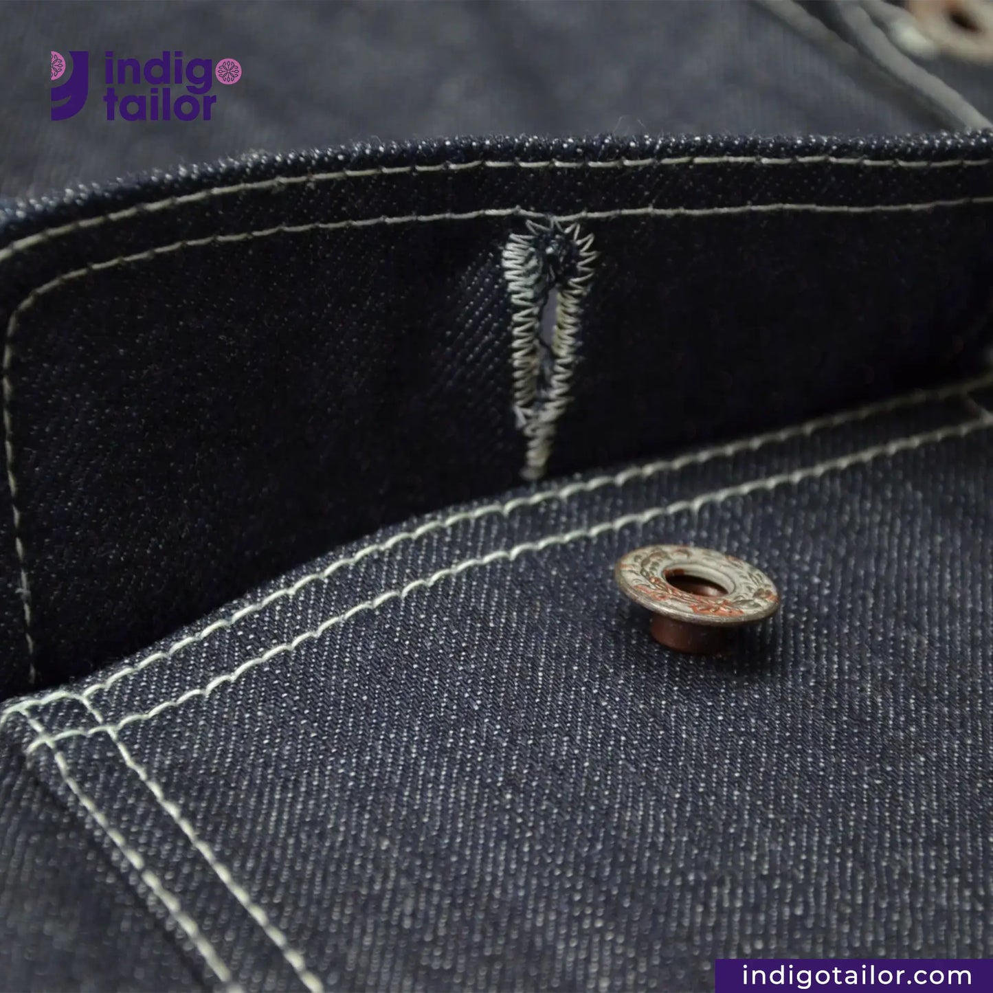 Close-up of a button on a DENIM CHORECOAT shirt with 'Indigotailor' branding.