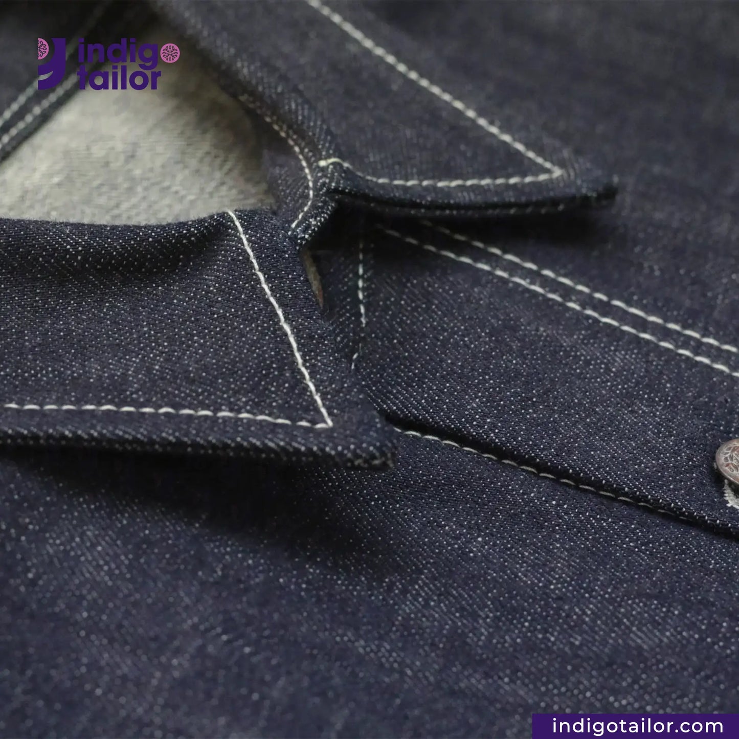 Close-up of DENIM CHORECOAT shirt with visible stitching, featuring the Indigotailor brand logo.