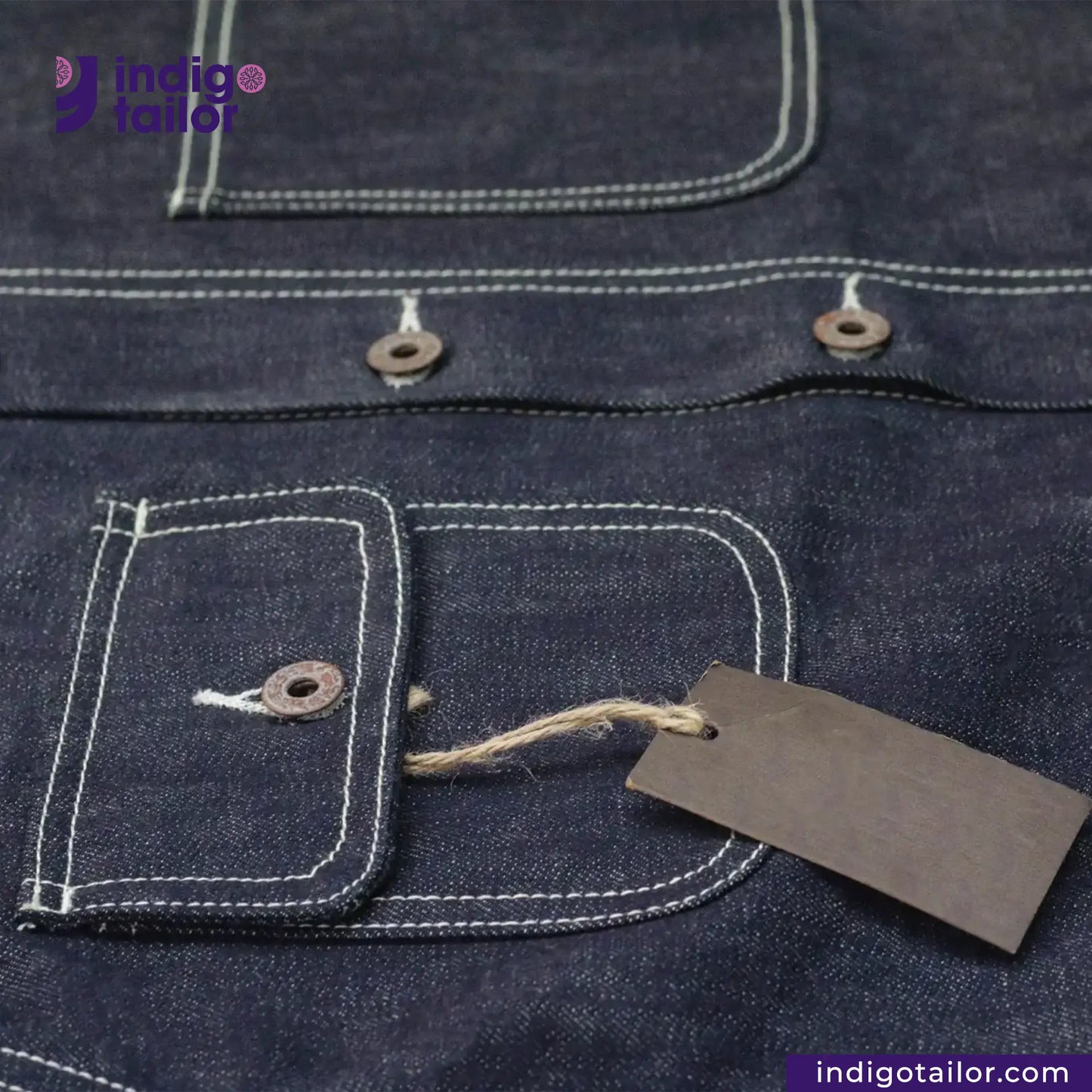 Close-up of a DENIM CHORECOAT Shirt with a tag and 'Indigotailor' branding.