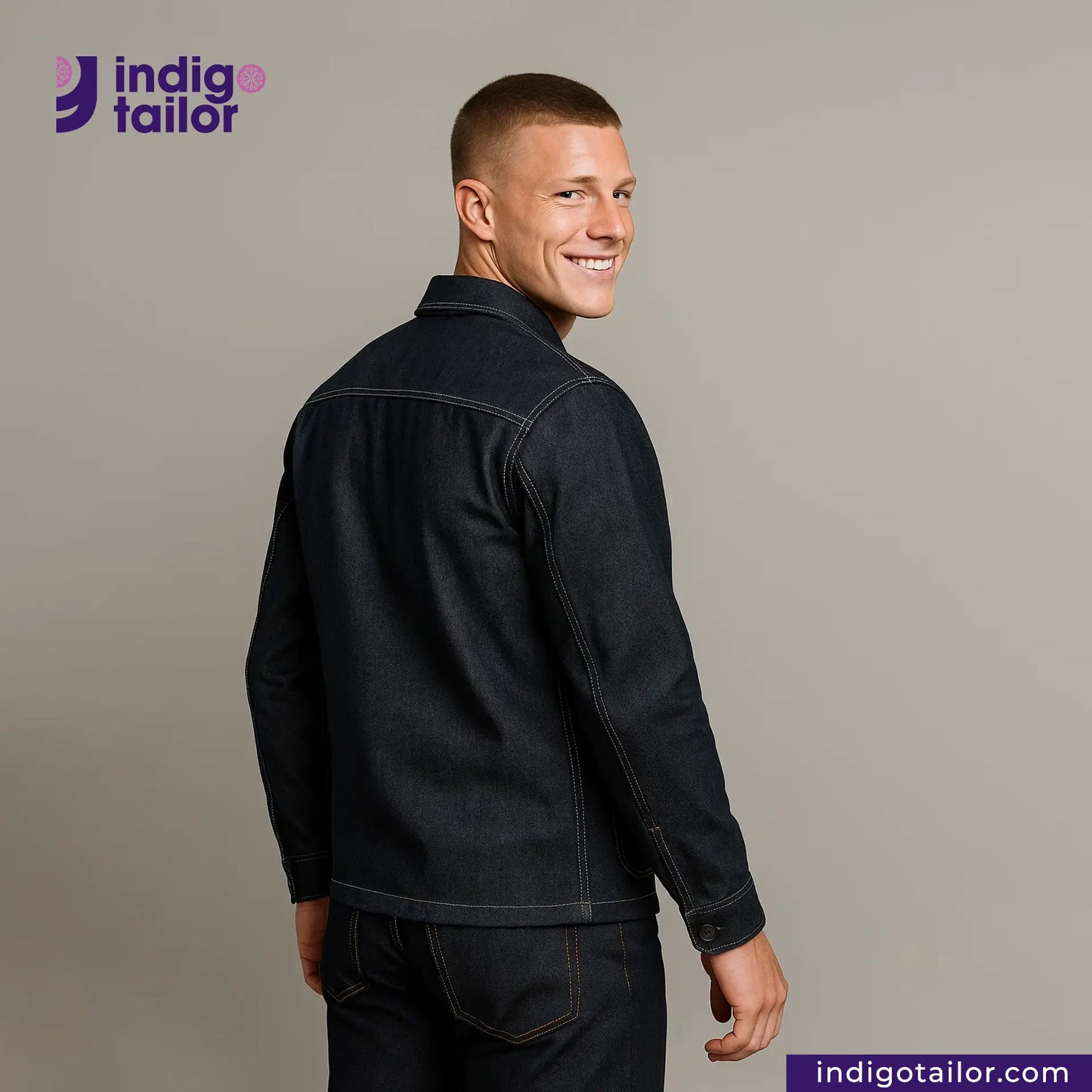 Man wearing a DENIM CHORECOAT jacket with 'Indigo Tailor' logo and website on a gray background