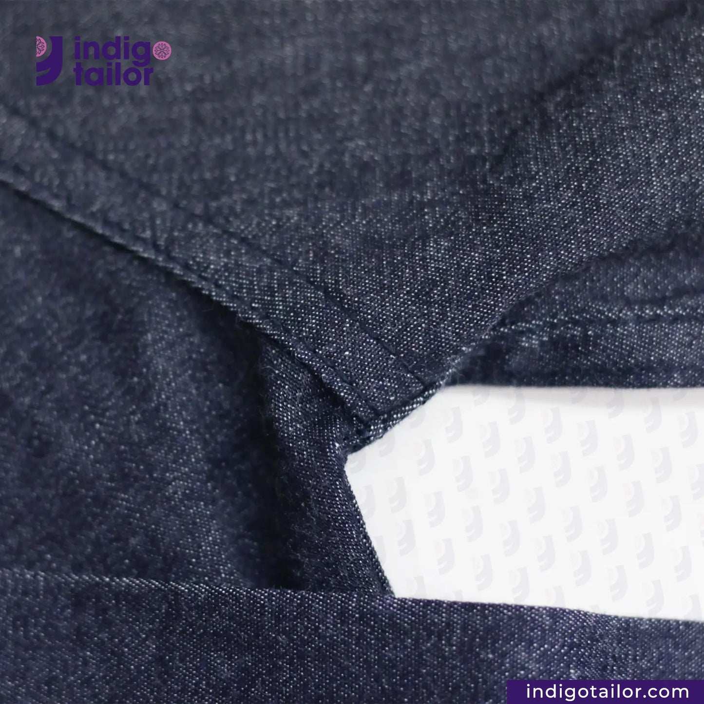 Close-up of DENIM HOODIE with a white label, featuring 'Indigotailor' branding.