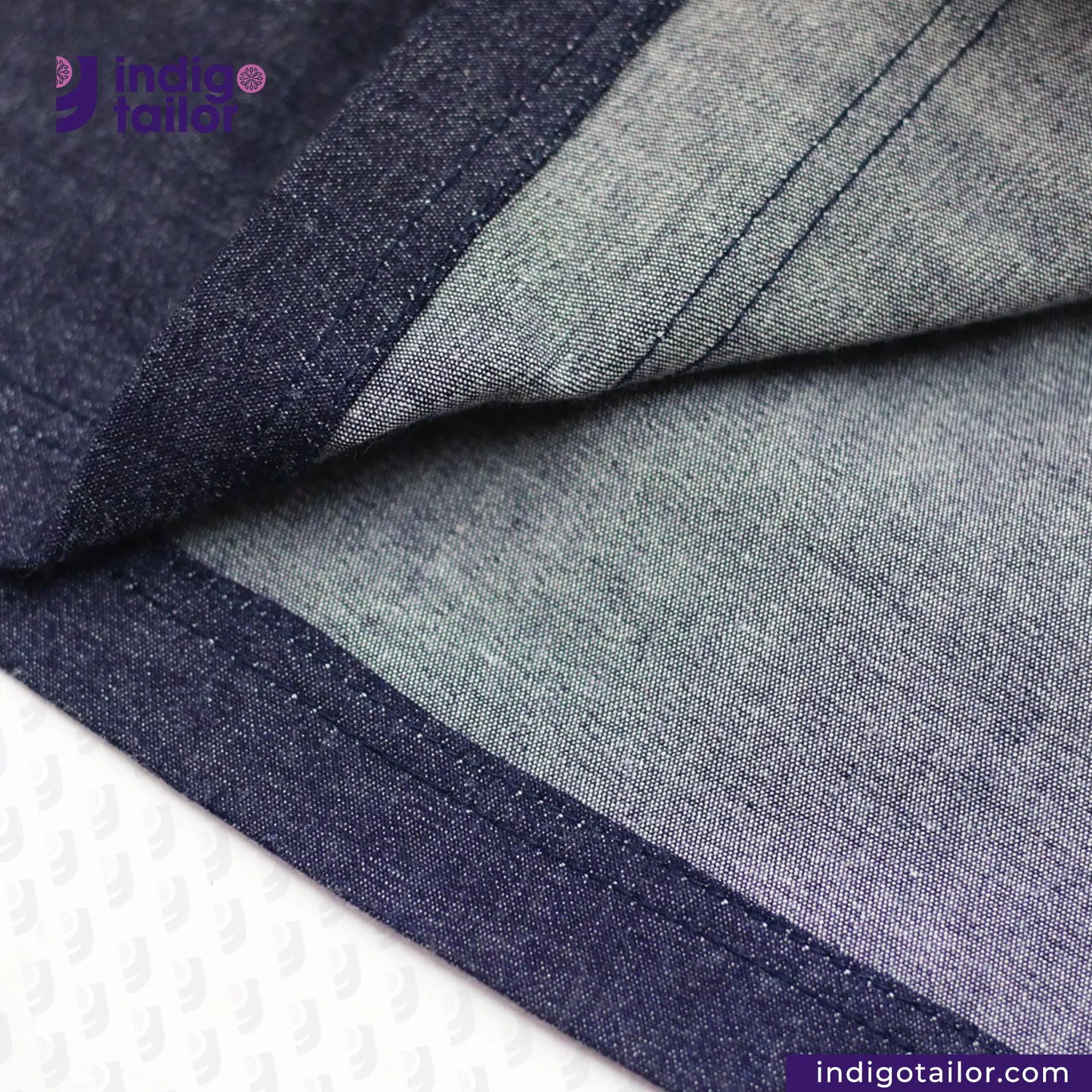Close-up of DENIM HOODIE with 'Indigo Tailor' branding.