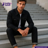 Man sitting on steps wearing a DOUBLE BLACK OREO SELVEDGE DENIM jacket and jeans with 'Indigotailor' branding.