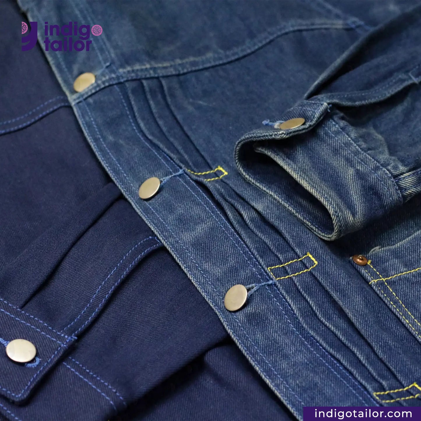 Close-up of a DOUBLE DIPPED TRIPLE PLEAT REPRO denim jacket with visible branding and stitching details.