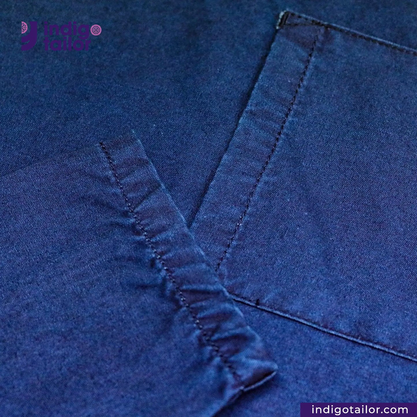 Close-up of EASY JACKET INDIGO CANVAS with stitching detail, featuring 'indigotailor.com' logo.