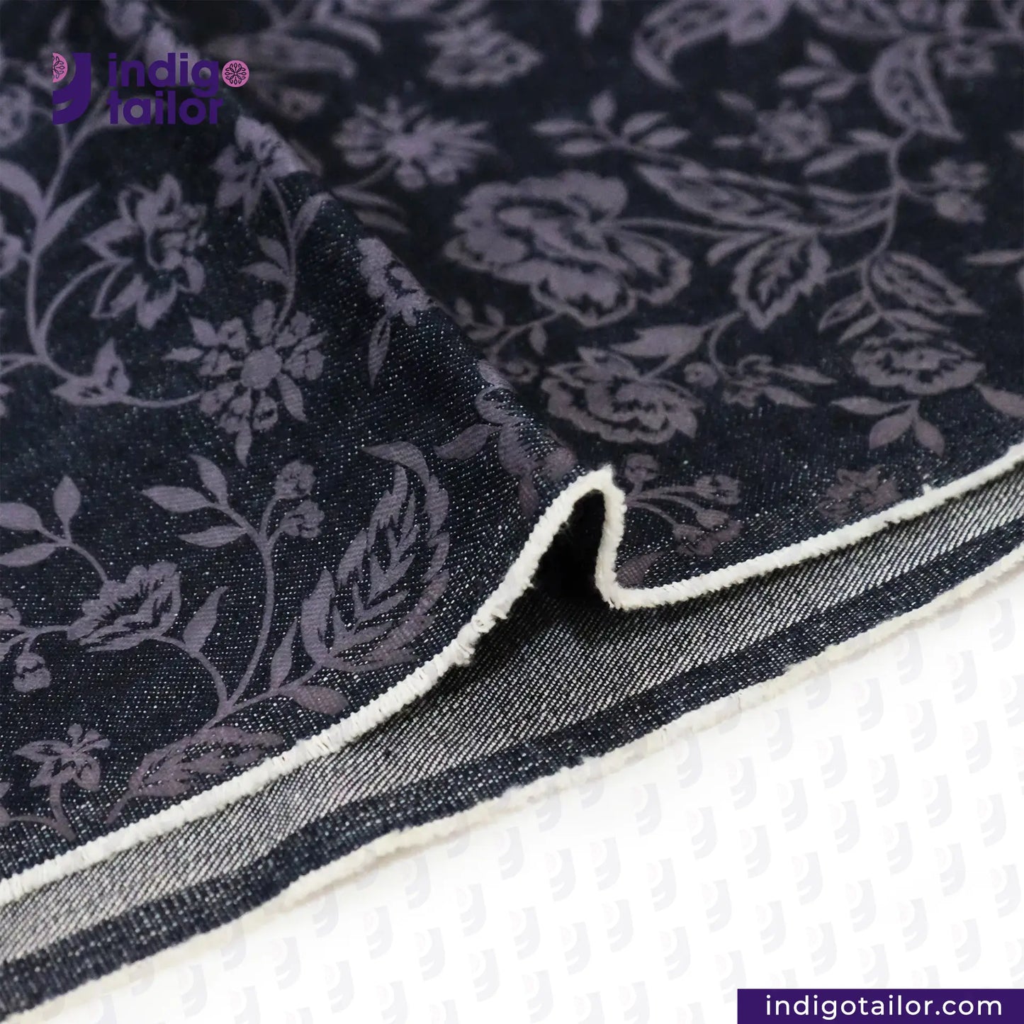 FLORAL EMBOSSED DENIM fabric with white border on a white background, featuring Indigotailor.com branding.