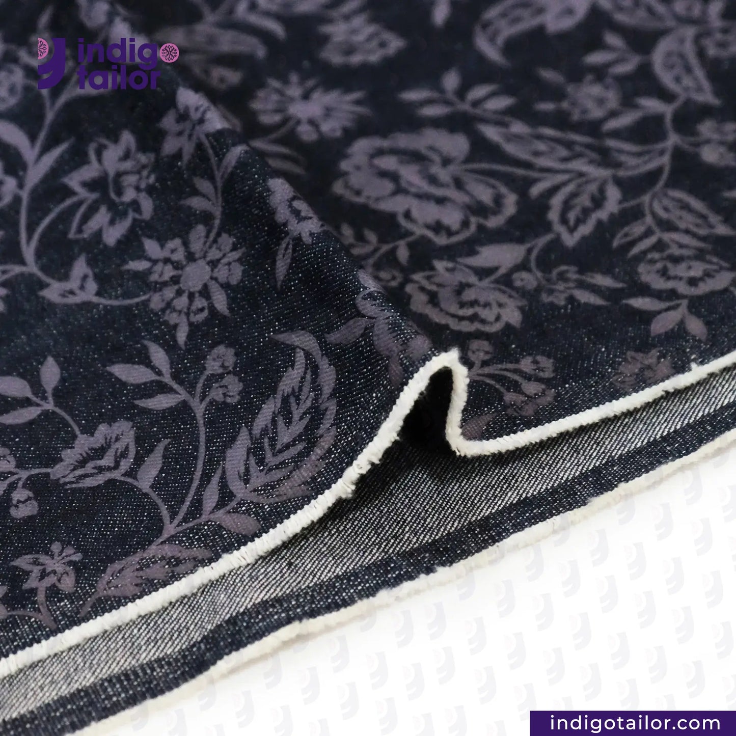 FLORAL EMBOSSED DENIM fabric with white border on a white background, featuring Indigo Tailor logo.