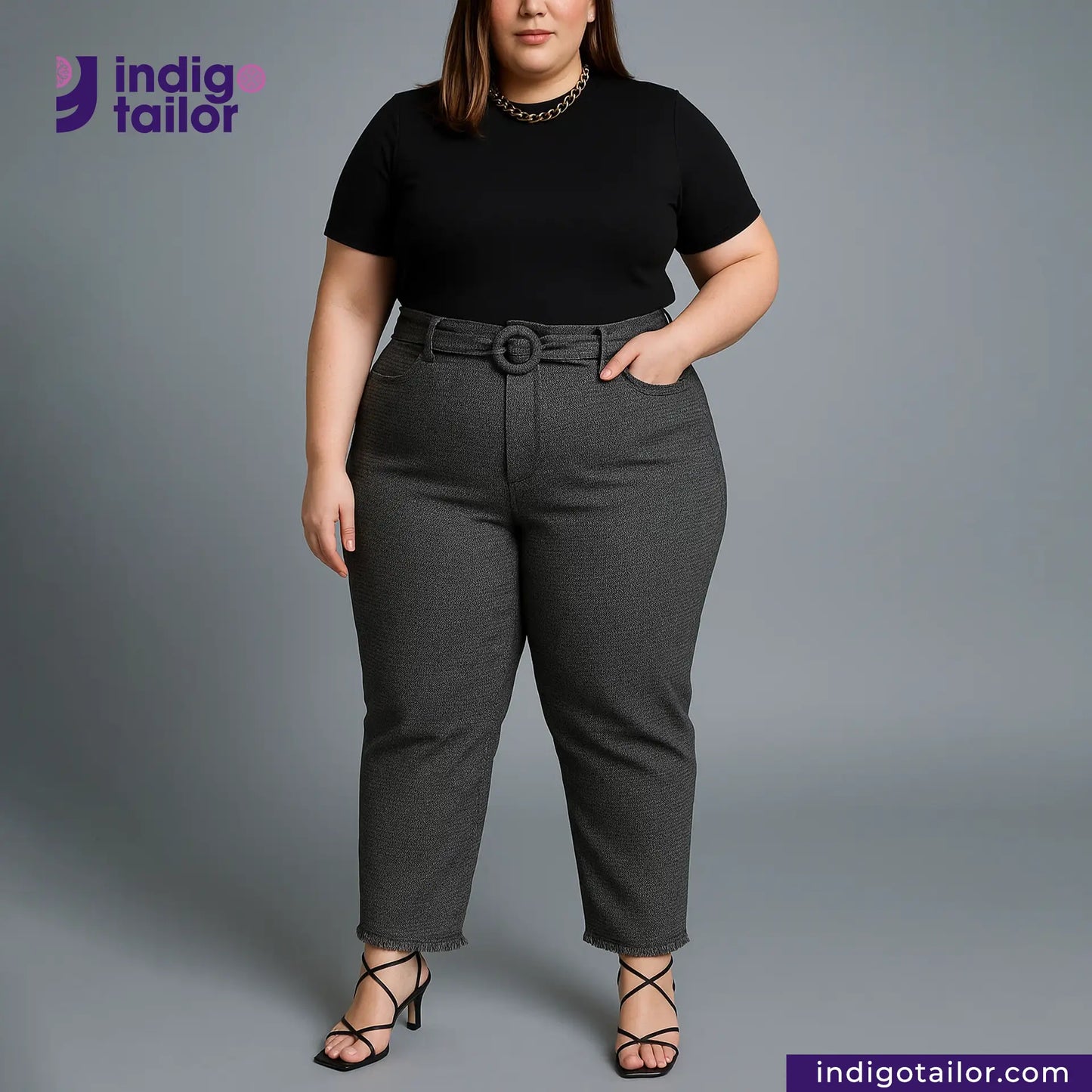 Woman wearing a black top and GREYHOUND TWEED HOUNDSTOOTH pants with an Indigo Tailor logo on a gray background
