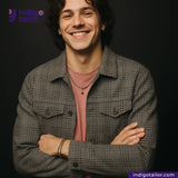 Man wearing a GREYHOUND TWEED HOUNDSTOOTH shirt over a pink shirt with 'Indigo Tailor' logo.
