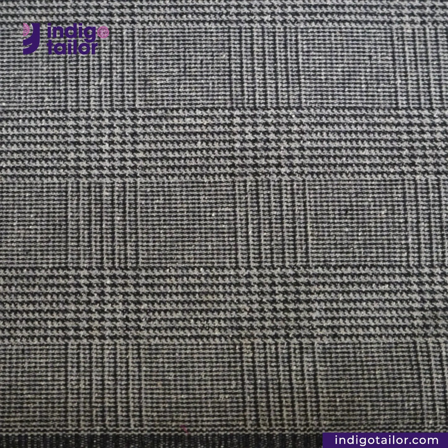 Close-up of GREYHOUND TWEED PLAID fabric with Indigotailor logo and website.