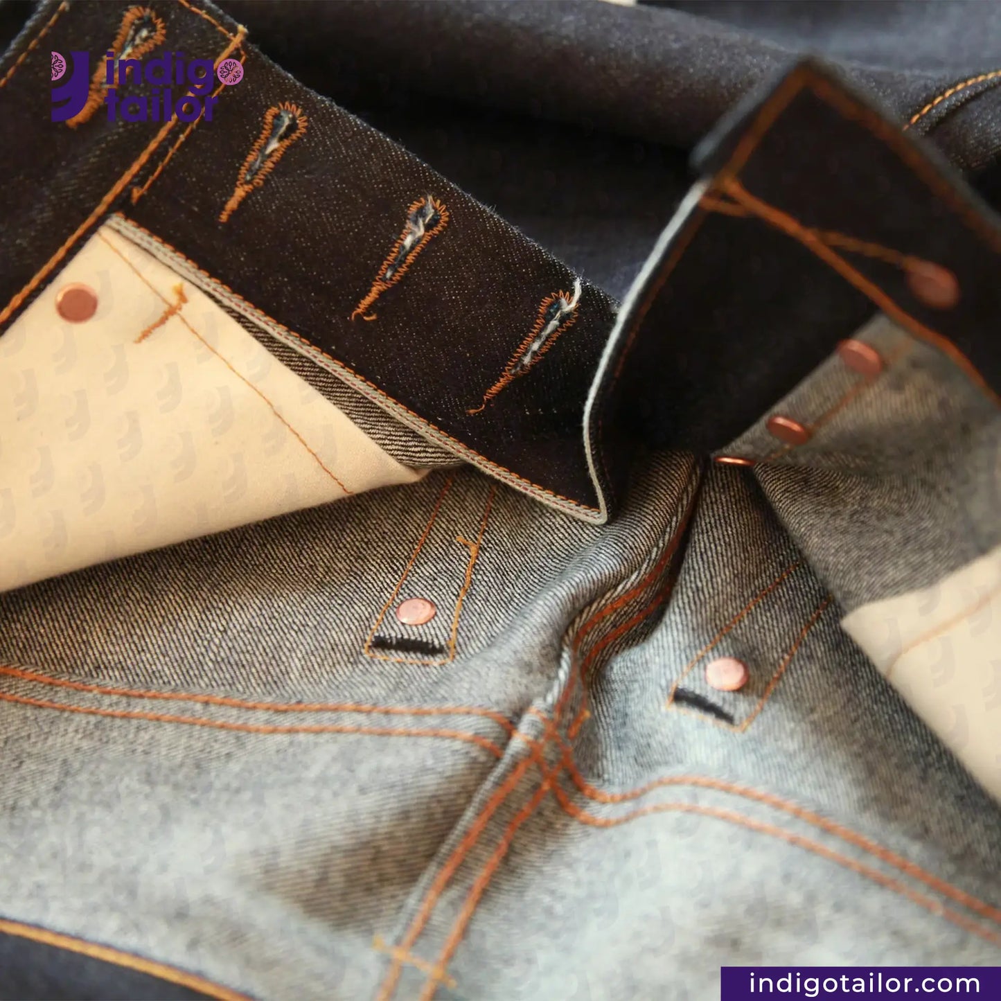 Close-up of denim fabric with stitching details, featuring 'Indigo Tailor' branding.