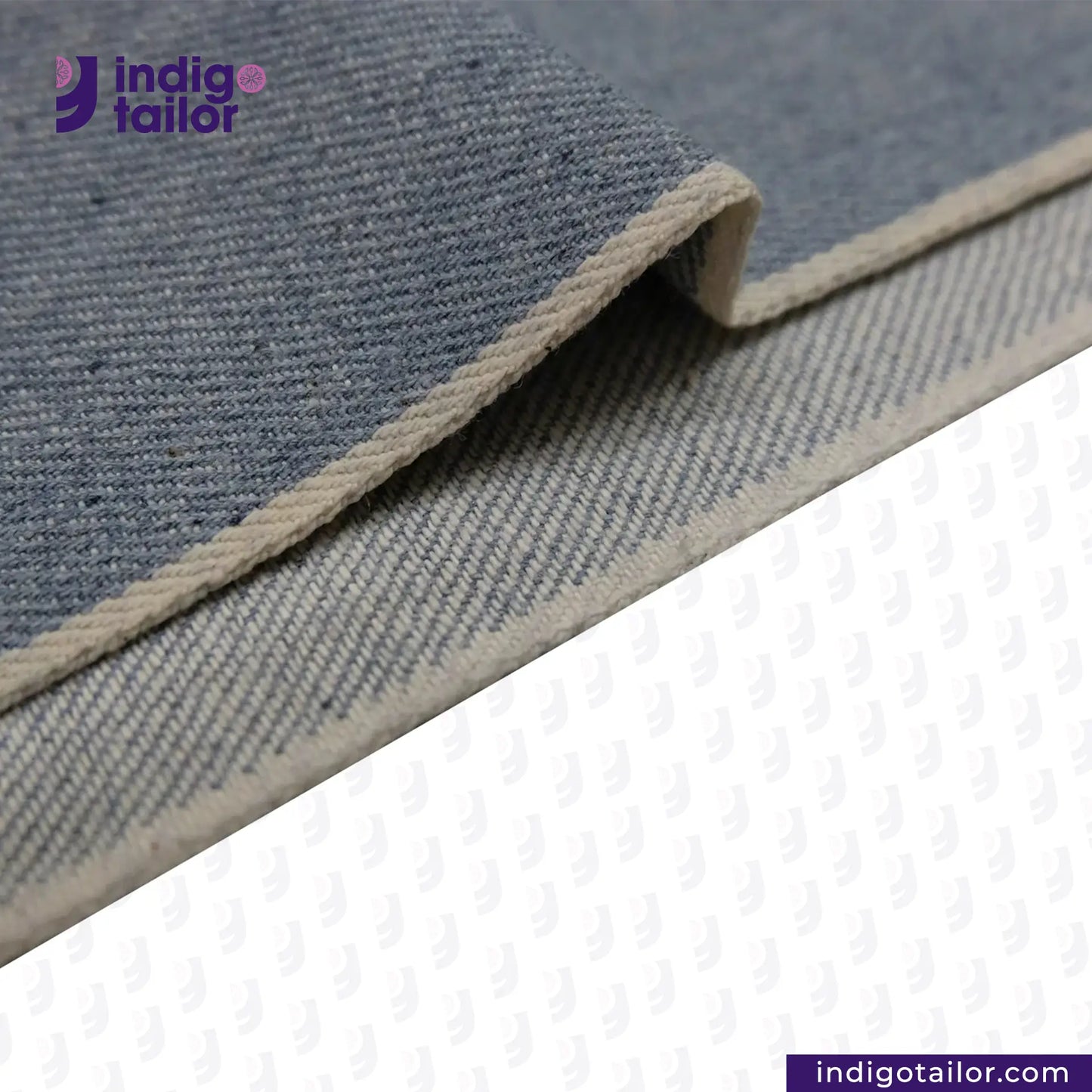 Close-up of ICE BLUE SELVEDGE DENIM fabric with a visible brand logo on a white background