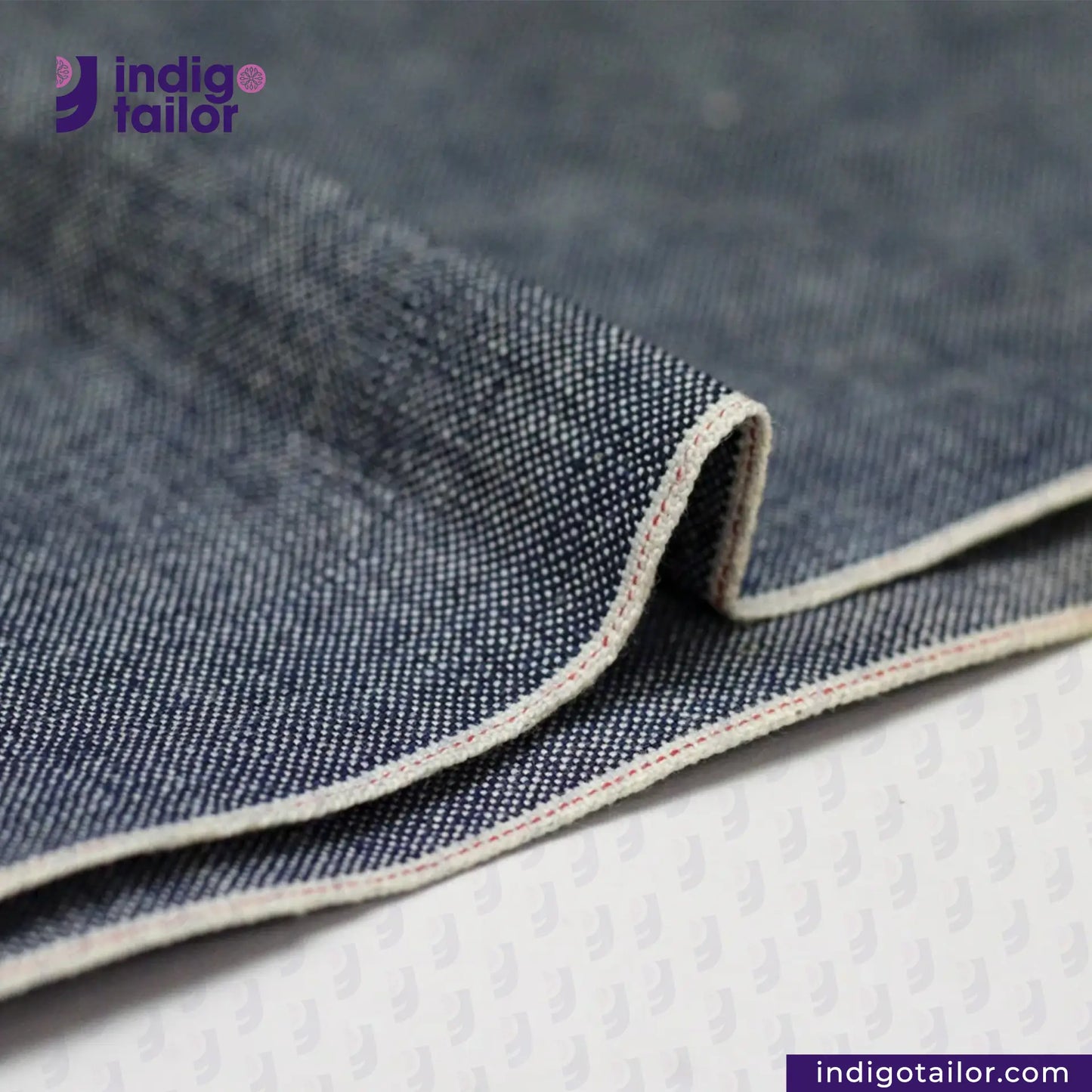 Close-up of INDIGO DUCK CANVAS fabric with 'indigotailor' branding.