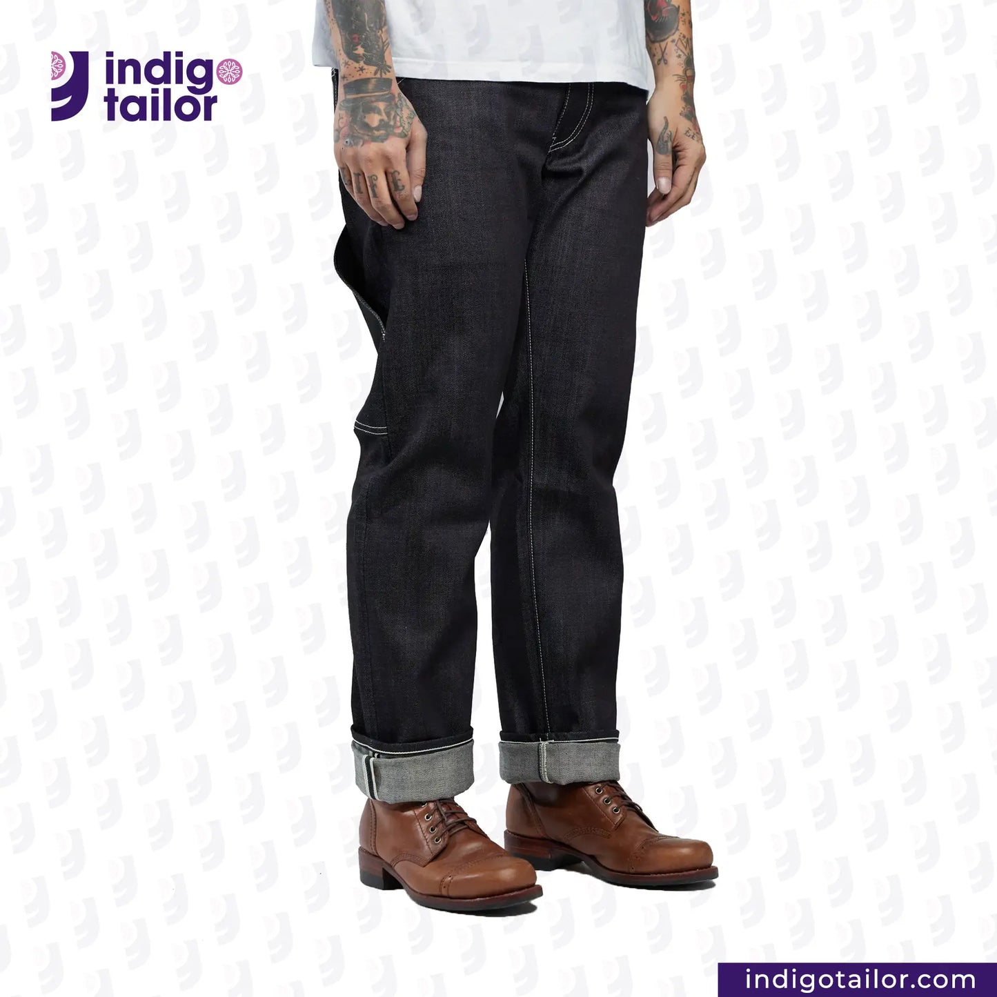 Person wearing INDIGO GREY DENIM jeans with rolled-up cuffs and brown shoes on a white background, featuring the Indigotailor logo.