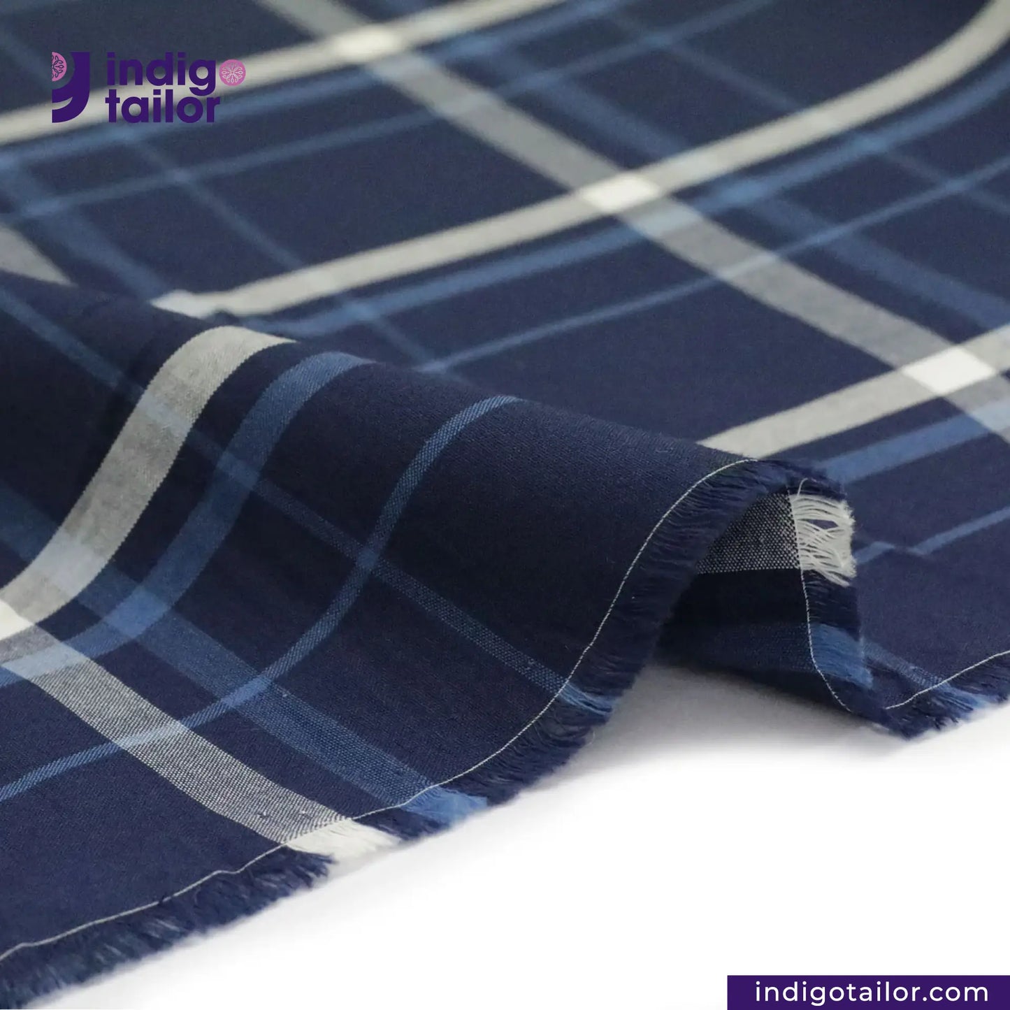 Close-up of INDIGO PLAID fabric with 'Indigotailor' branding.