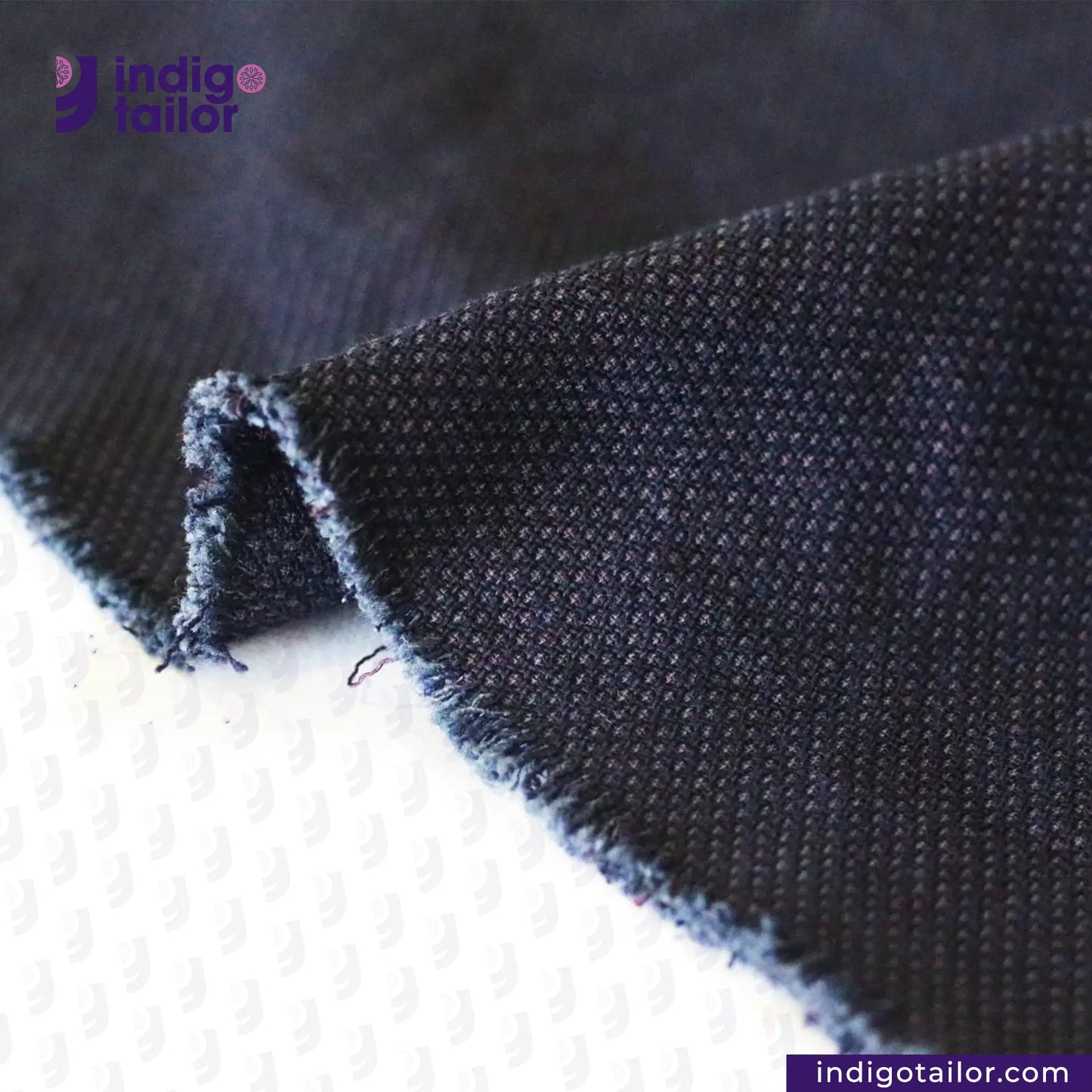 Close-up of INDIGO SASHIKO fabric with 'Indigo Tailor' branding.