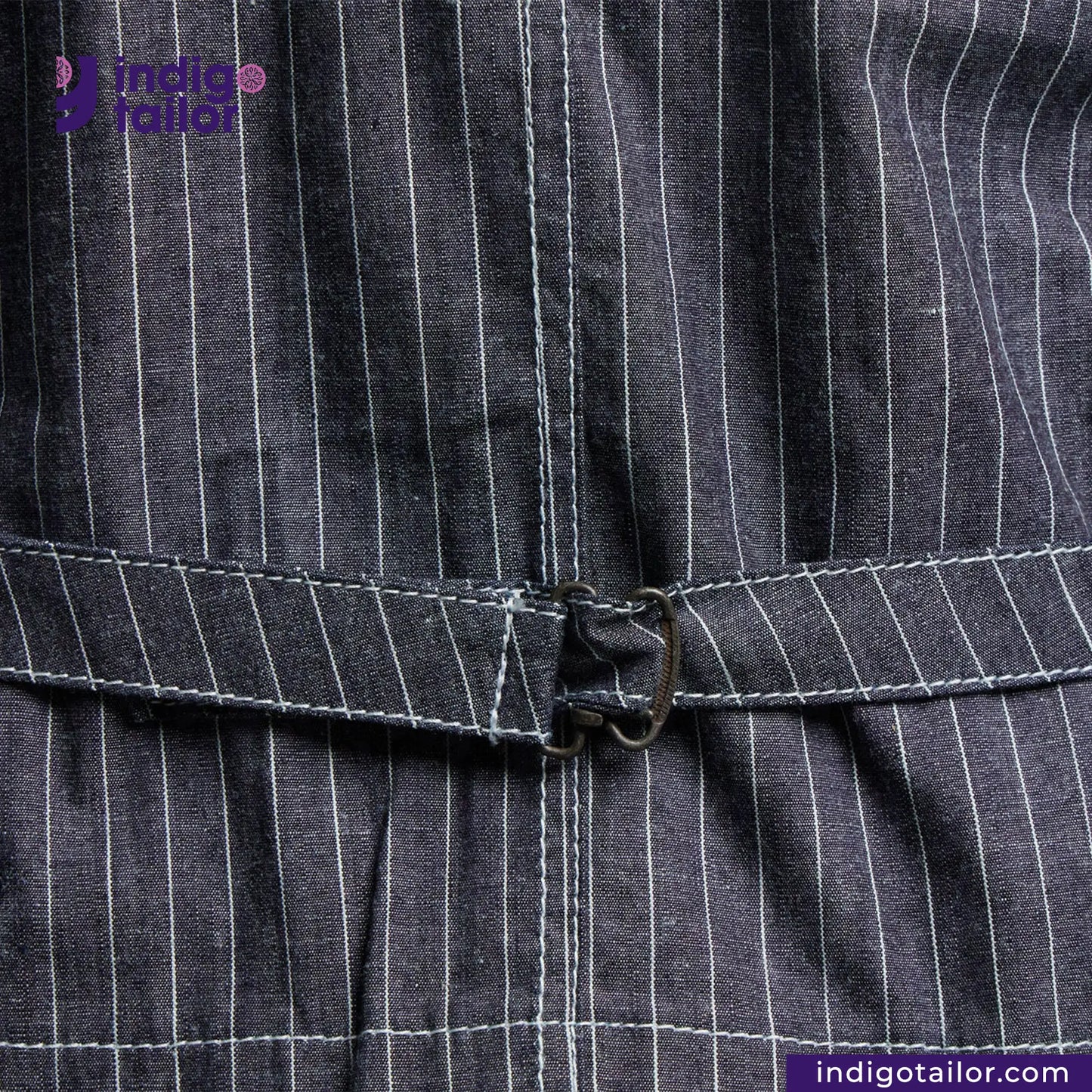 Close-up of a INDIGO VINTAGE STRIPE WORK VEST with a belt, featuring the Indigotailor logo.