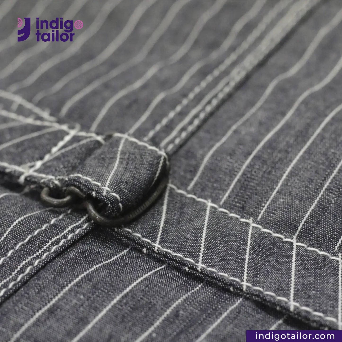 Close-up of a button on a INDIGO VINTAGE STRIPE WORK VEST with 'Indigotailor' branding.