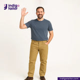 Man wearing a blue shirt and KHAKI SLUB DENIM pants waving, with 'Indigo Tailor' logo above.
