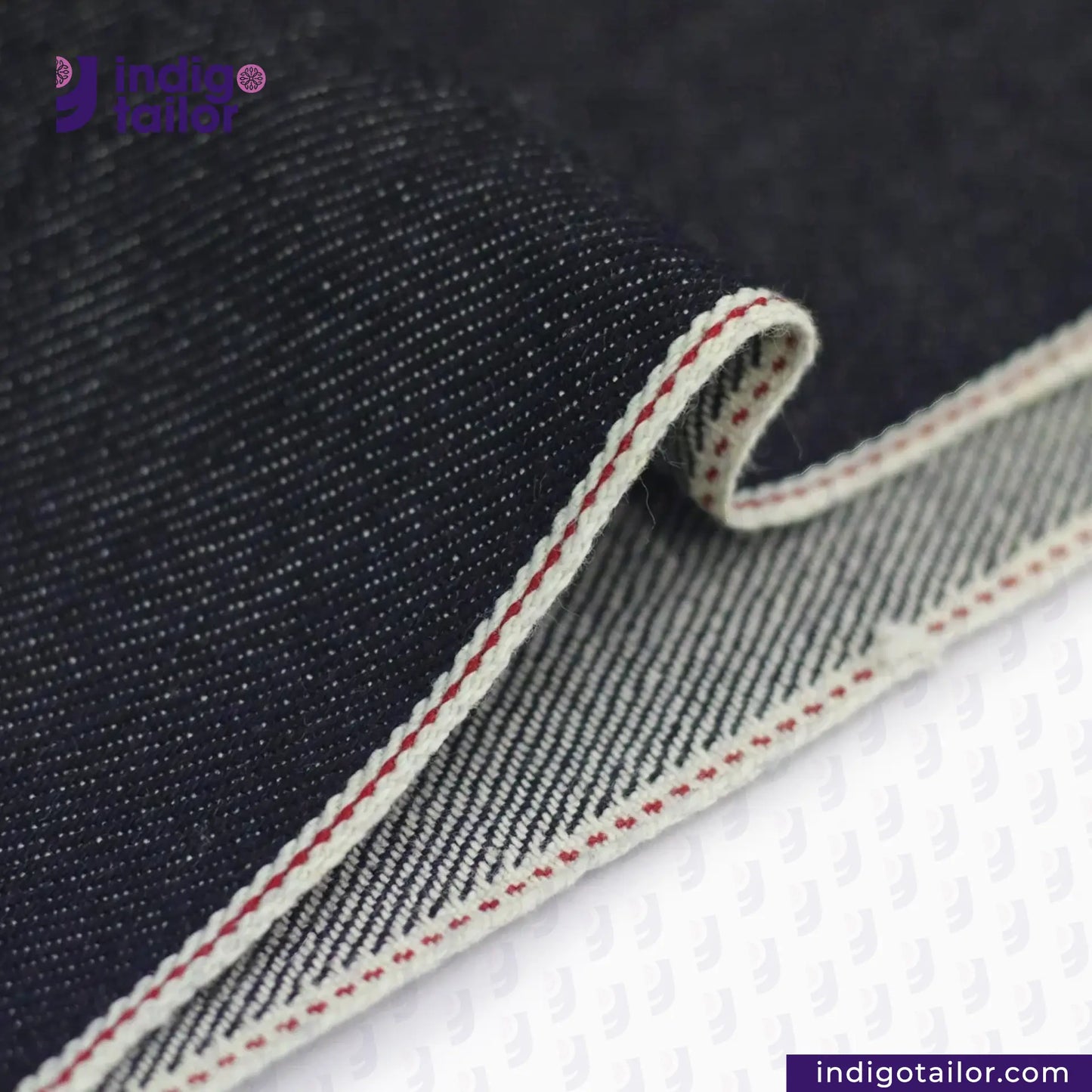 Close-up of KUROKI CLASSIC RED LINE SELVEDGE fabric with a visible brand logo and website.
