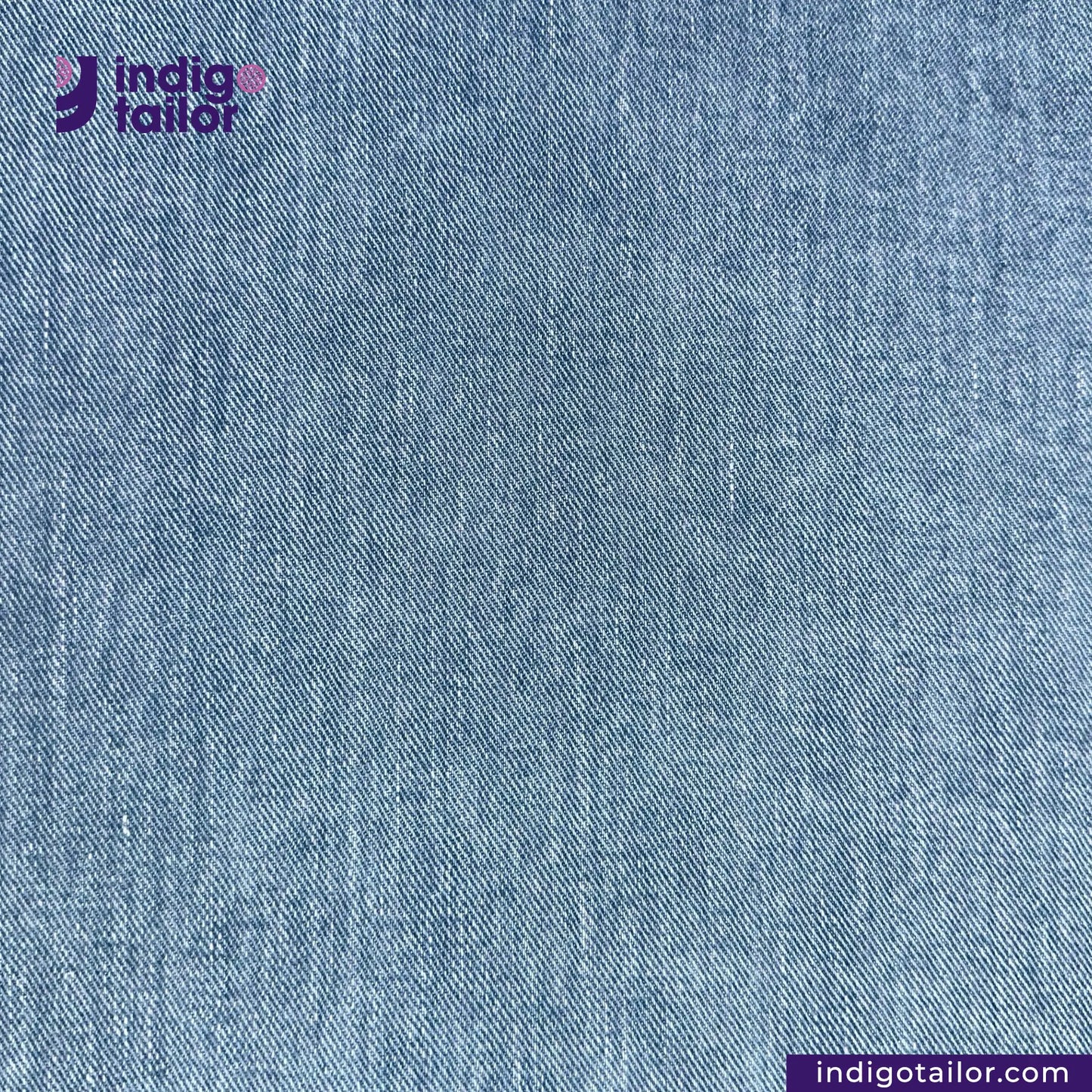 Close-up of LIGHT WASHED SELVEDGE DENIM LIME SELVEDGE ID fabric with 'Indigotailor' logo and website URL.