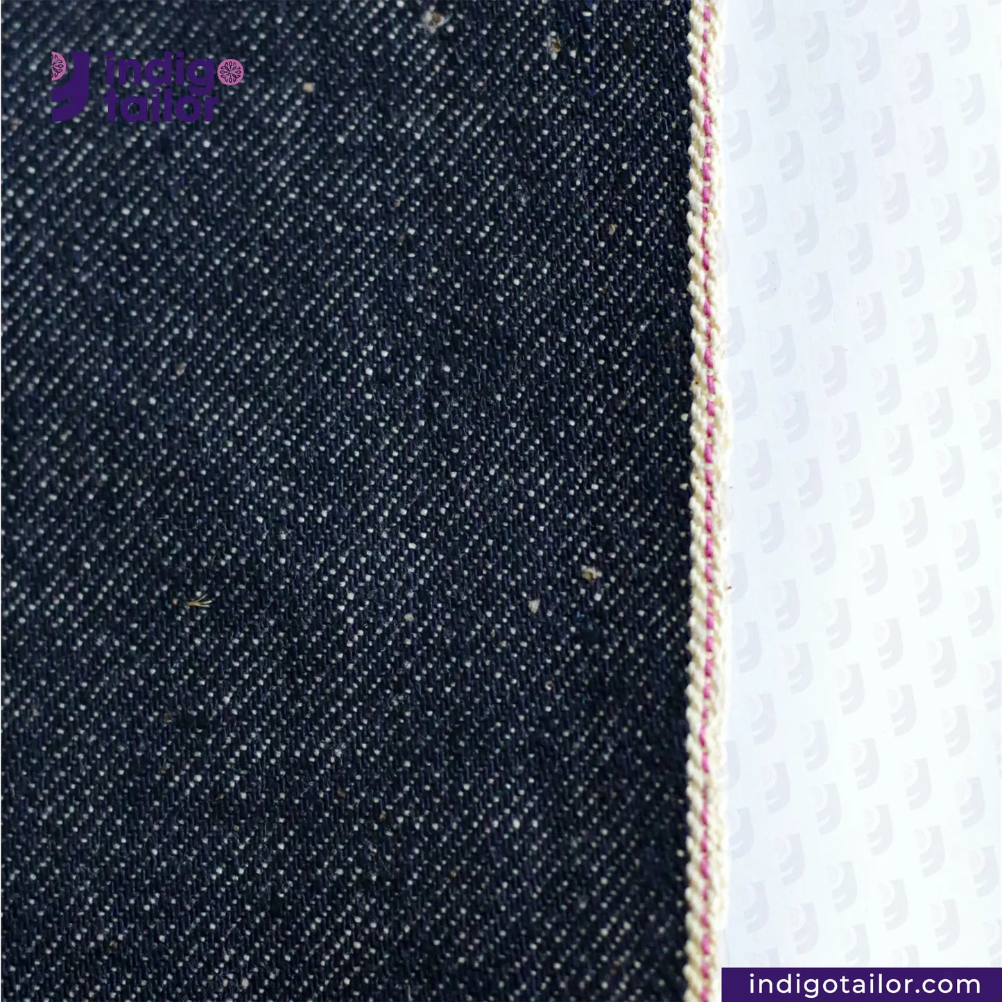 Close-up of LOW TENSION SLUBBY, NEPPY AND HEAVY SELVEDGE DENIM fabric with a white background, featuring the Indigo Tailor logo.