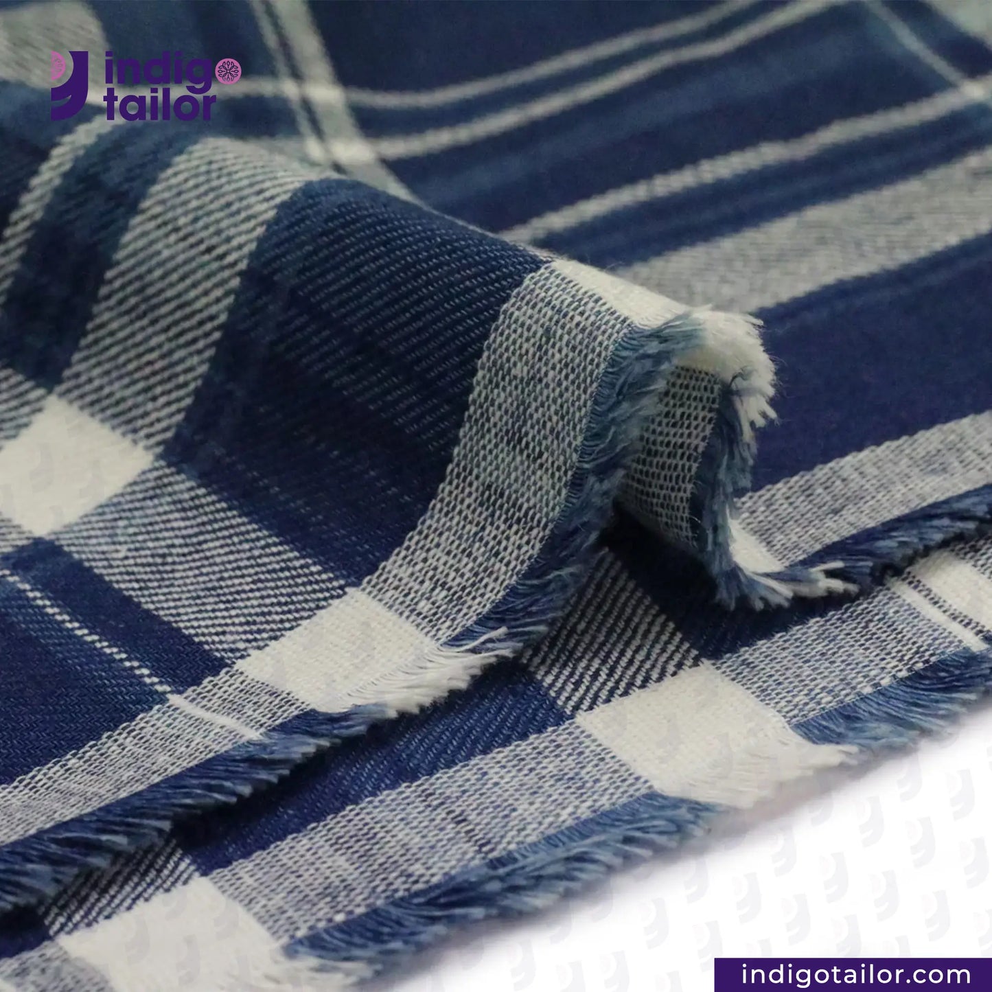 Close-up of MADRAS SPRING BLUE WHITE CHECK fabric with 'Indigotailor' branding.