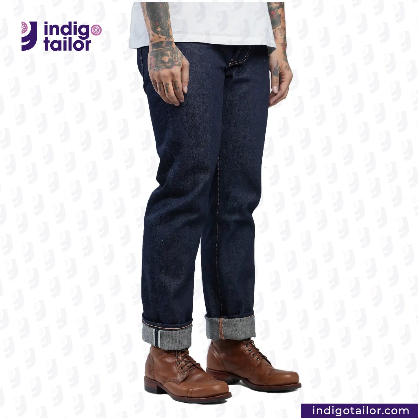 Person wearing MEDIUM BLUE DENIM LIVIDUS SELVEDGE jeans and brown shoes on a white background with 'Indigo Tailor' branding.