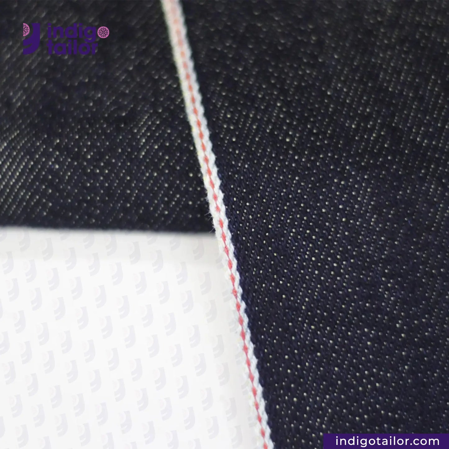 Close-up of METALLIC GOLD WEFT SELVEDGE DENIM fabric with a visible brand logo and website text.