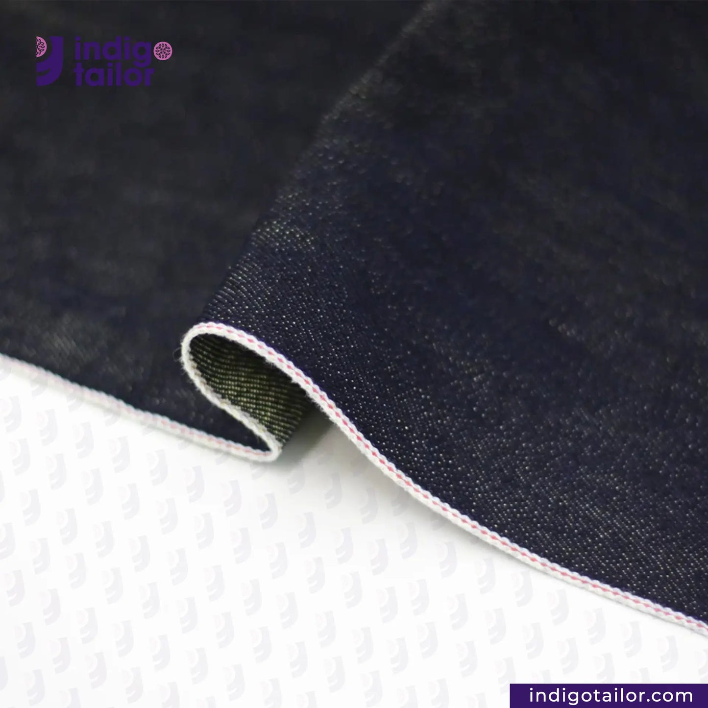 Close-up of METALLIC GOLD WEFT SELVEDGE DENIM fabric with 'indigotailor' branding on a white background