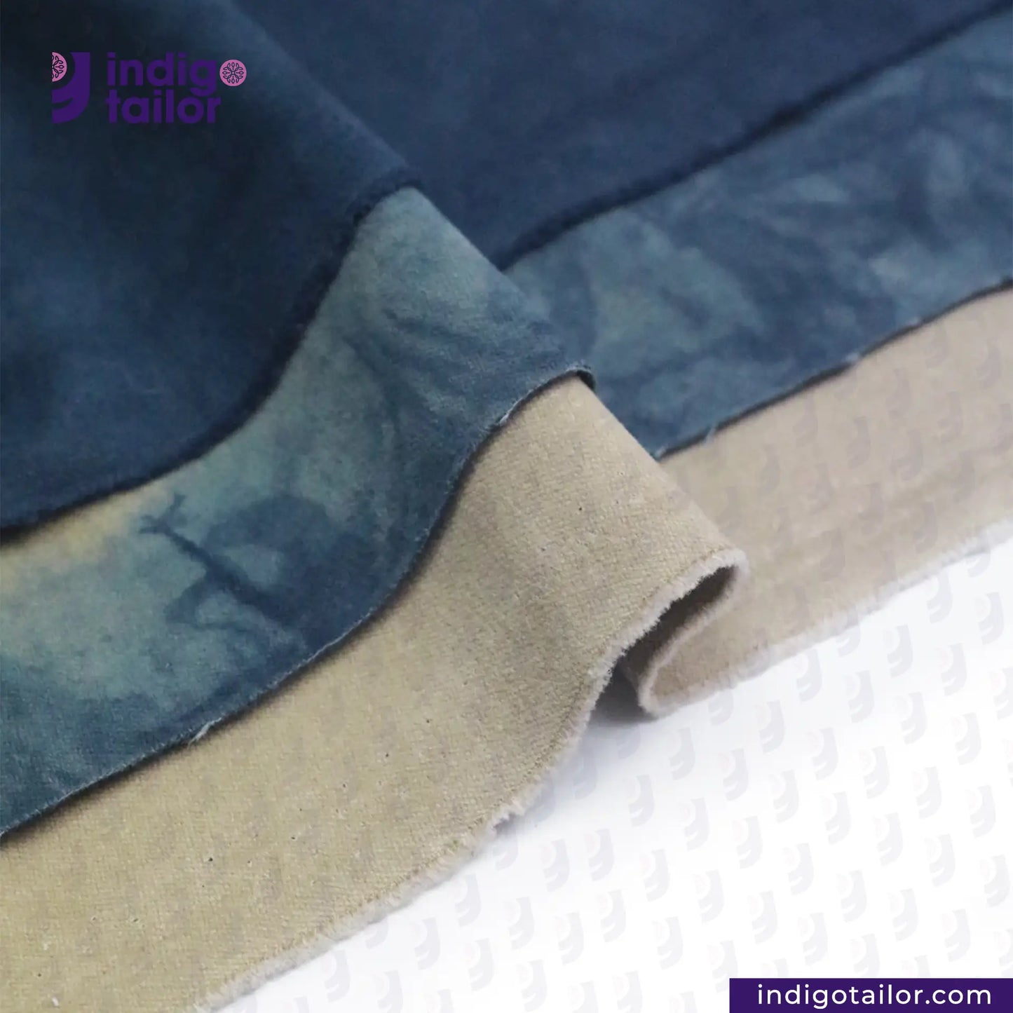 Close-up of NATURAL INDIGO DYED SUEDE fabric with 'Indigotailor' branding.