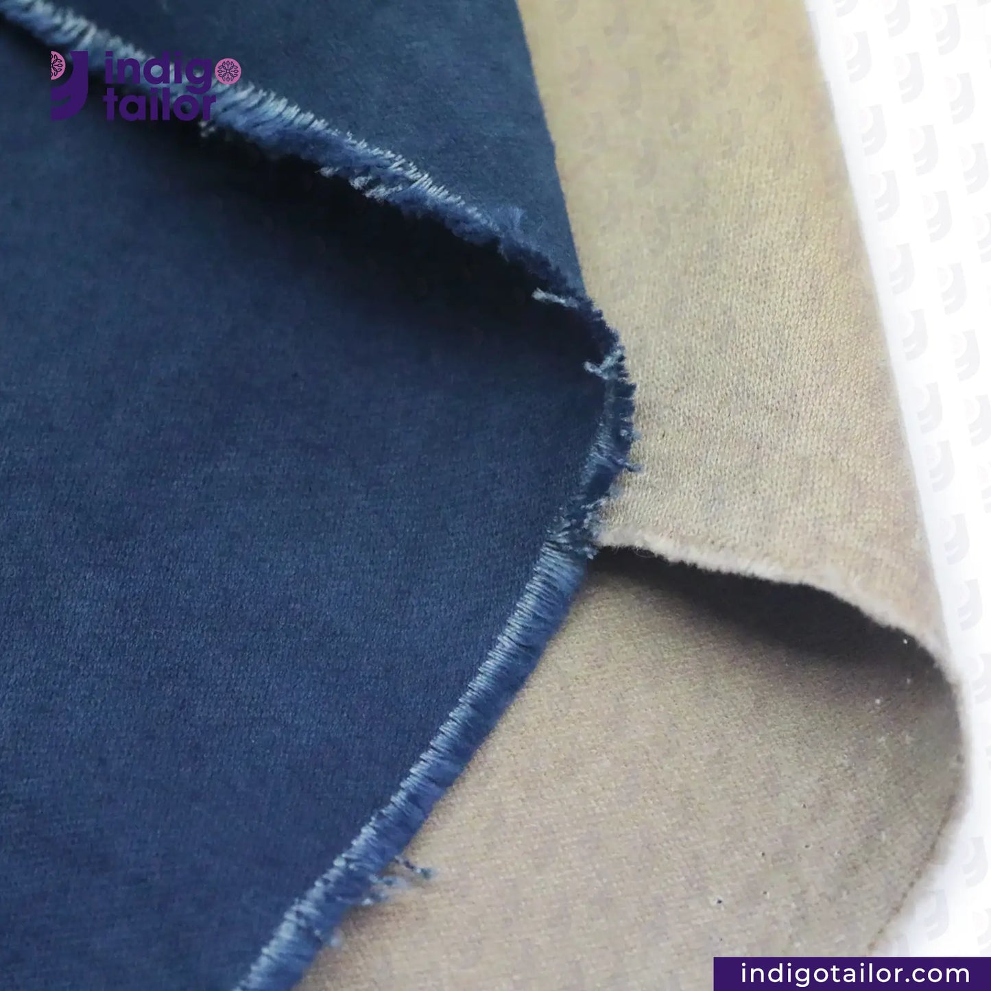 Close-up of NATURAL INDIGO DYED SUEDE fabric with 'Indigo Tailor' branding.