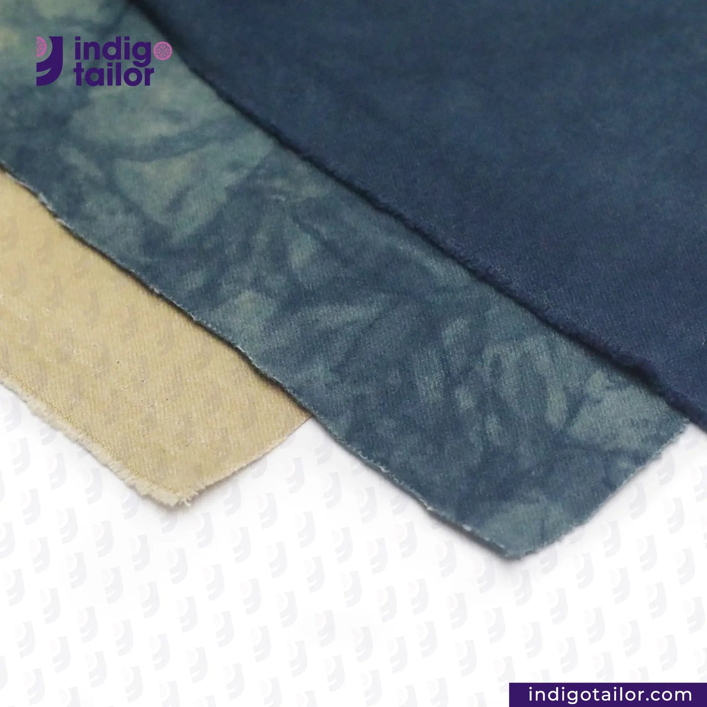 Close-up of NATURAL INDIGO DYED SUEDE with beige border on a white background, featuring 'indigotailor' branding.