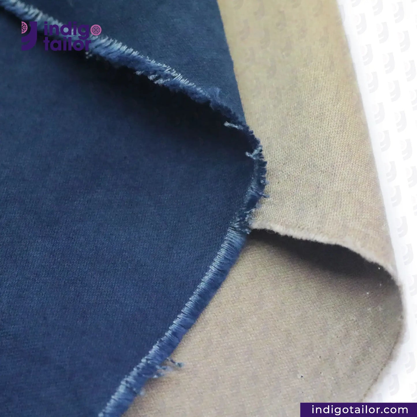 Close-up of NATURAL INDIGO DYED SUEDE fabric with 'Indigo Tailor' branding.