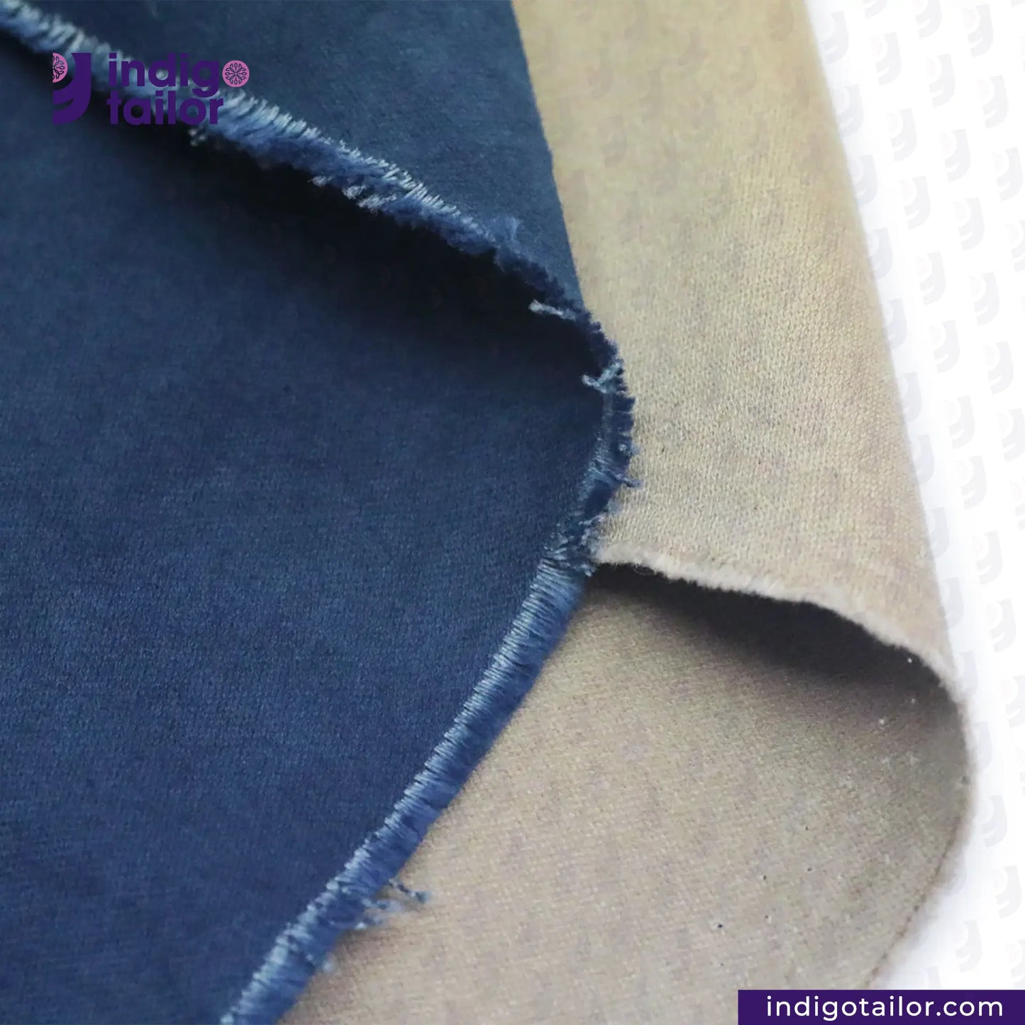Close-up of NATURAL INDIGO DYED SUEDE fabric with 'Indigo Tailor' branding.