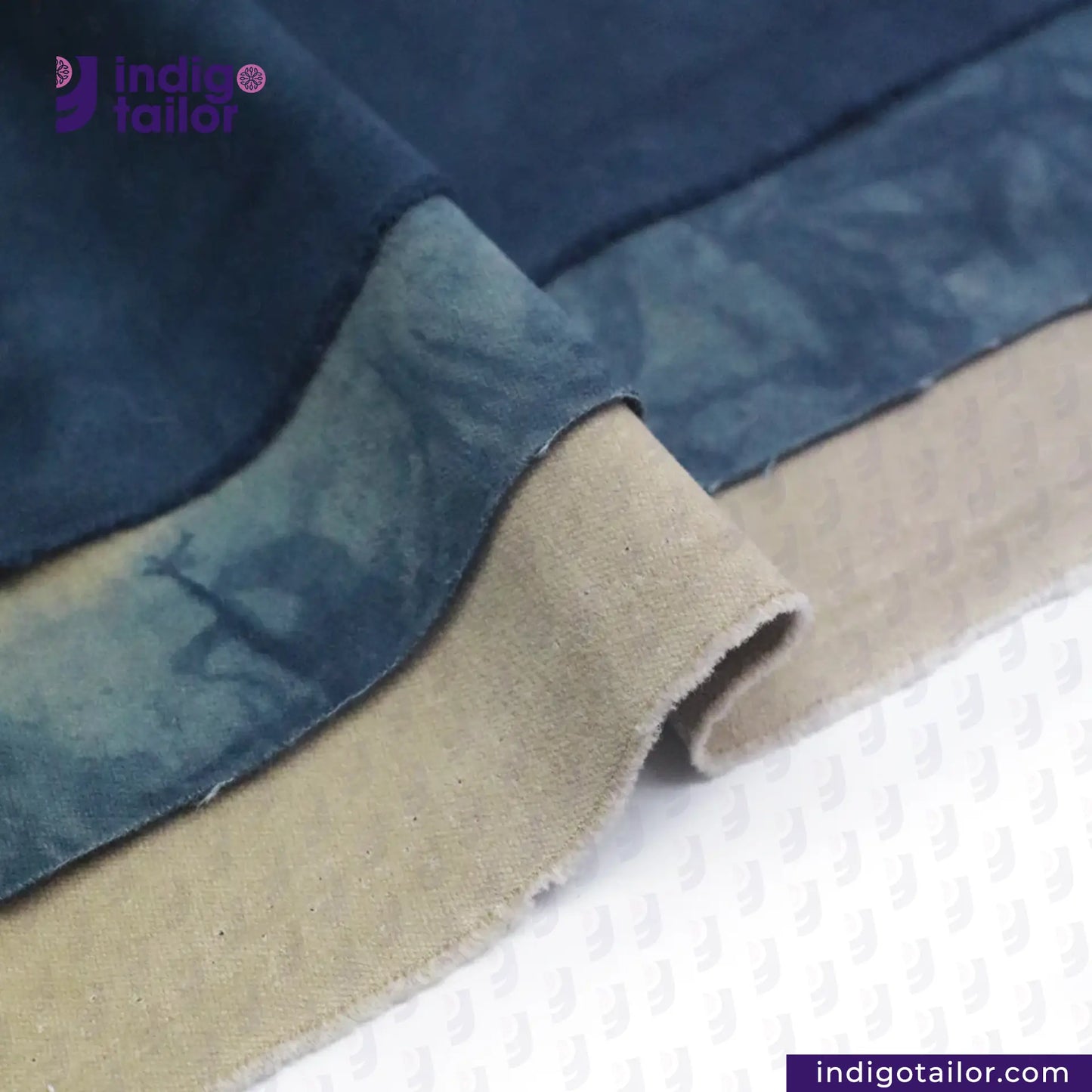Close-up of NATURAL INDIGO DYED SUEDE fabric with 'Indigotailor' branding.
