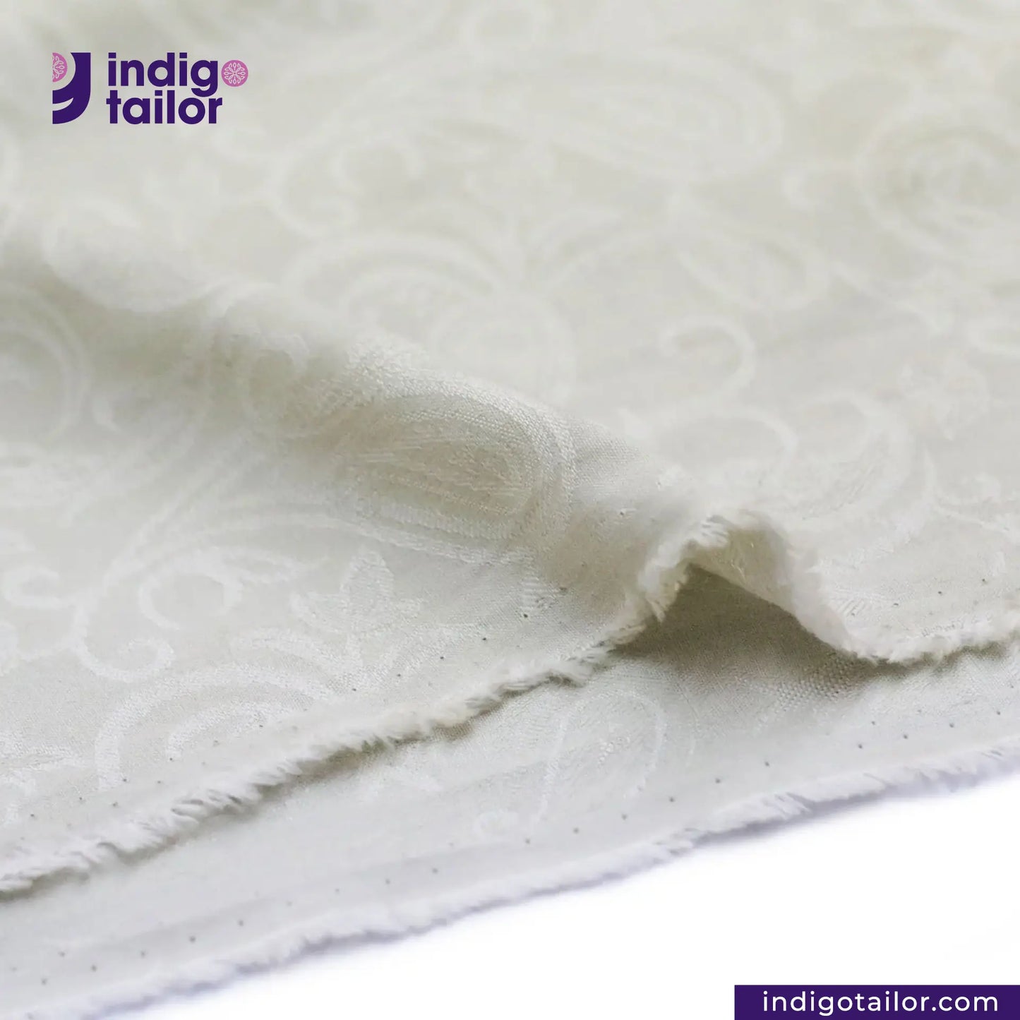 Close-up of OFF-WHITE PAISLEY JACQUARD fabric with 'indigotailor' logo and website.